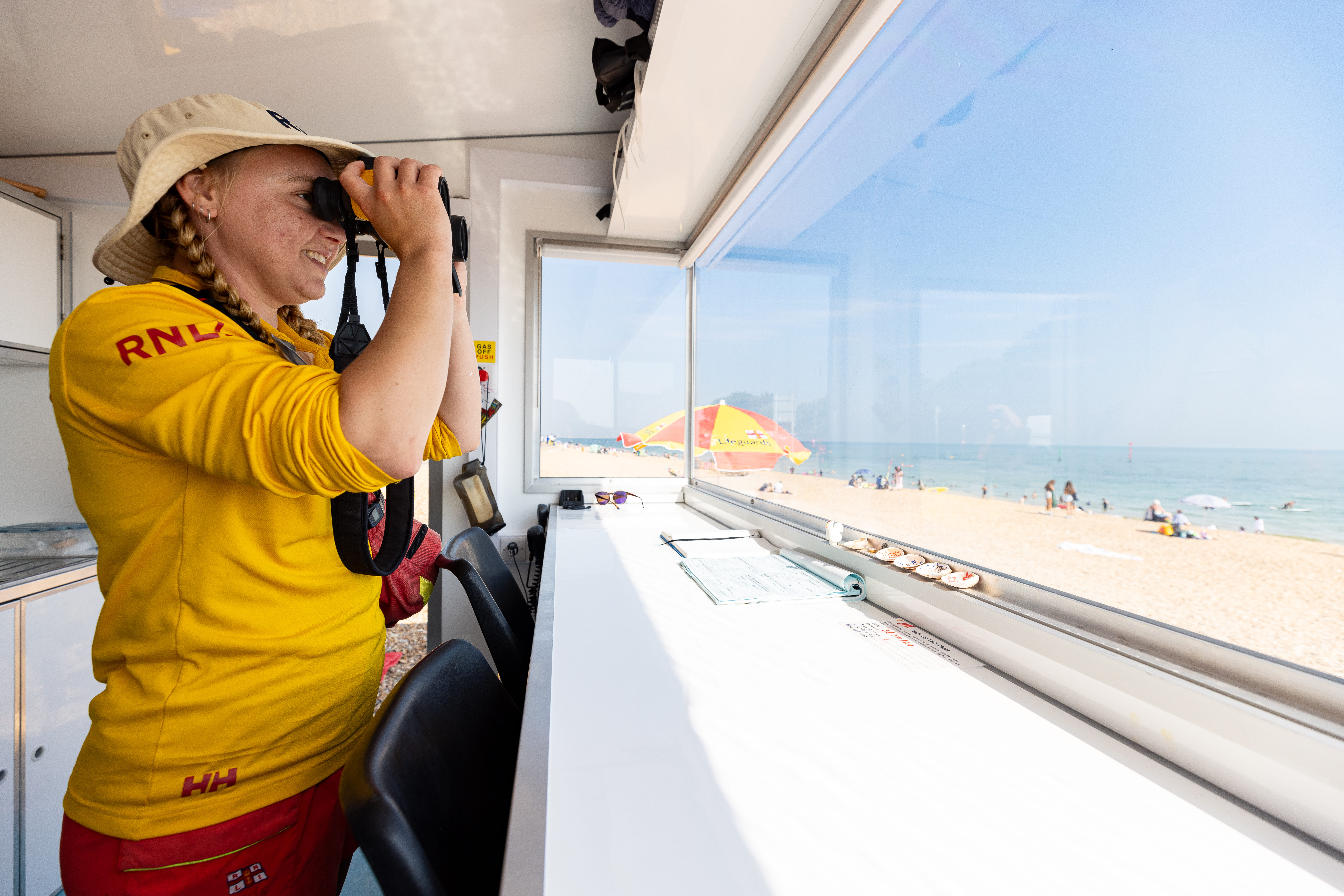 An RNLI lifeguard keeping watch over beach goers
