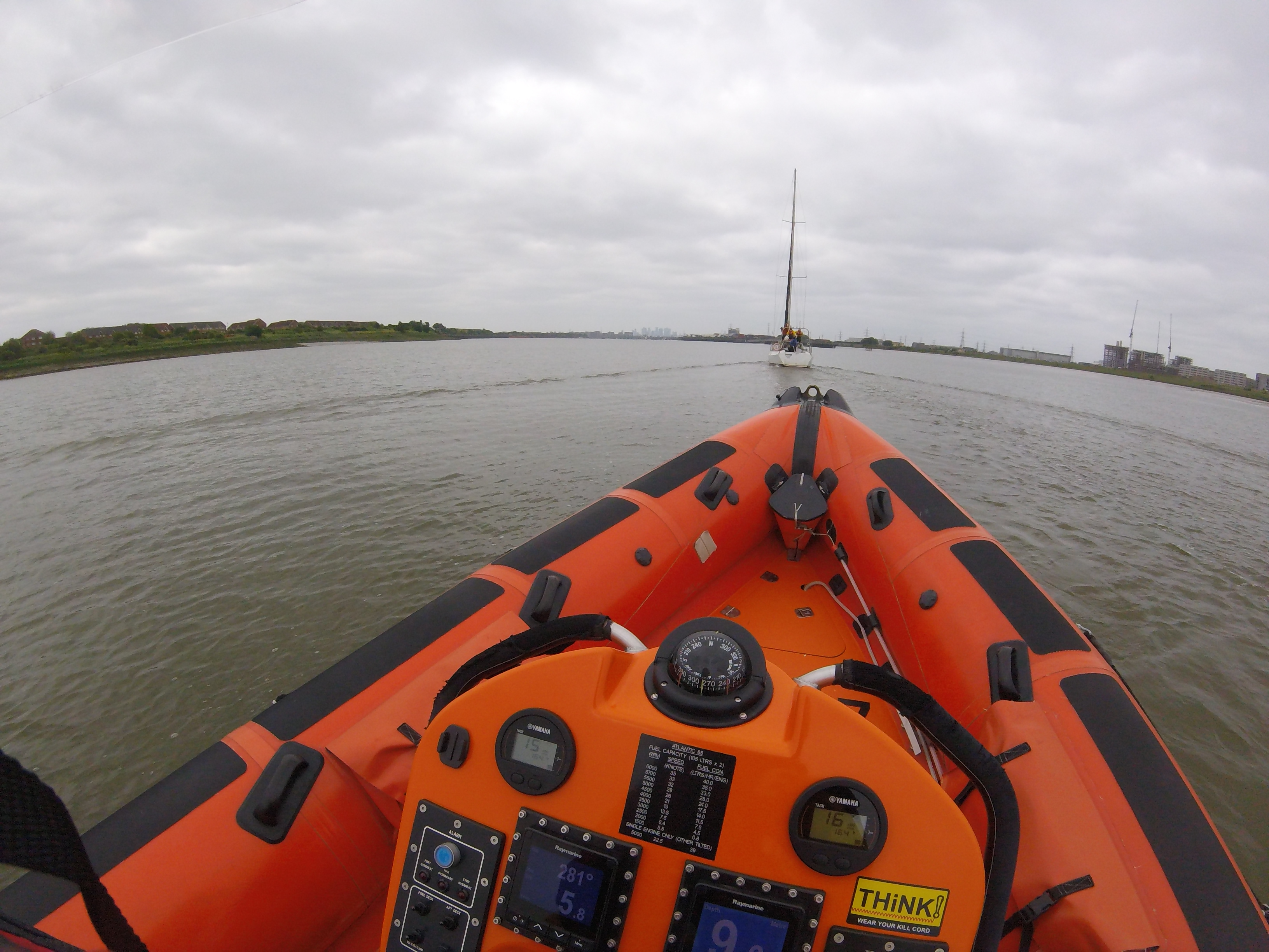 Gravesend RNLI's lifeboat following white sailing yacht