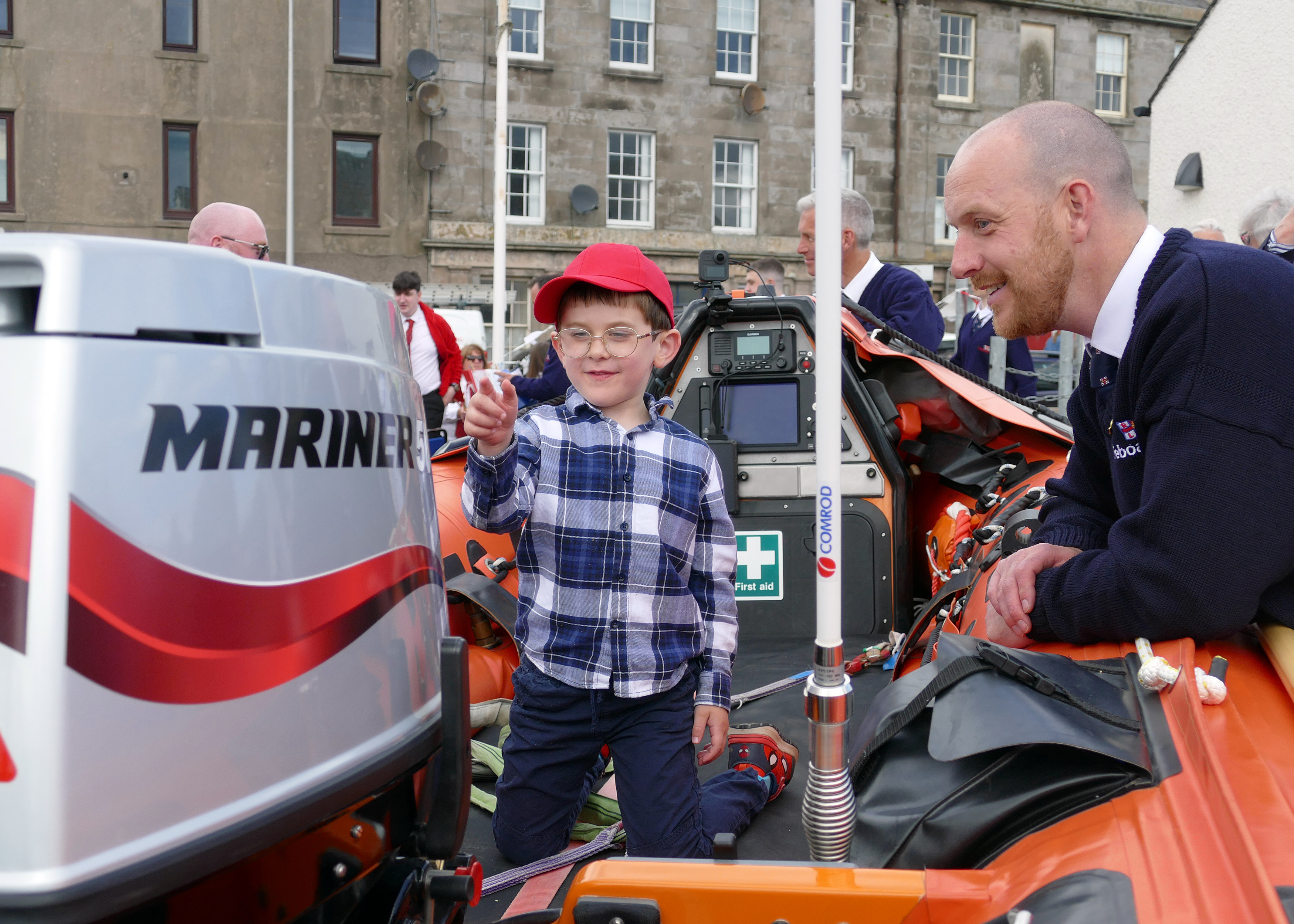 Volunteer lifeboat crew Matt Duncan with his son Jacob on the lifeboat Margaret Olive