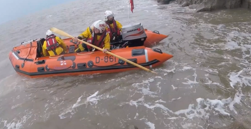 The inshore lifeboat veering towards teh cliff edge 