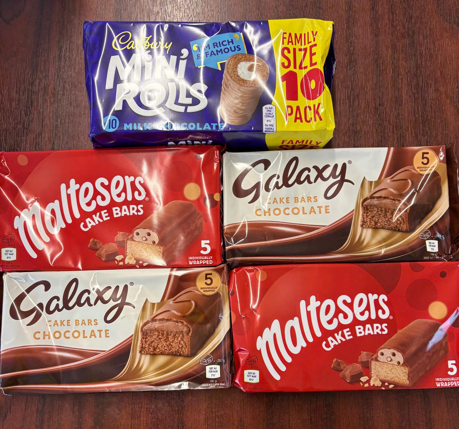 Photo of a range of cake chocolate bars laid out on a table. 