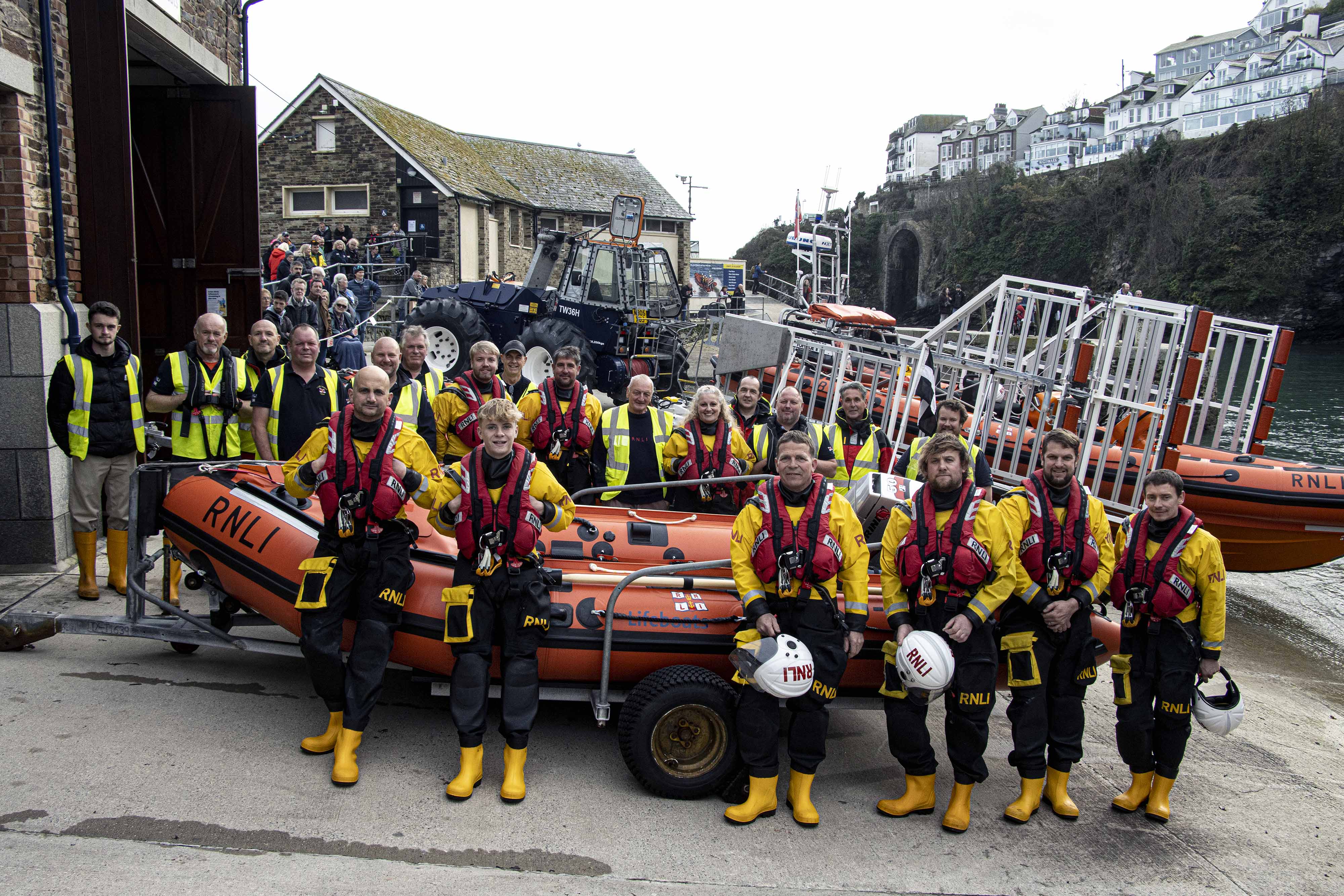 Stock image - Looe RNLI volunteer crew outside the lifeboat station