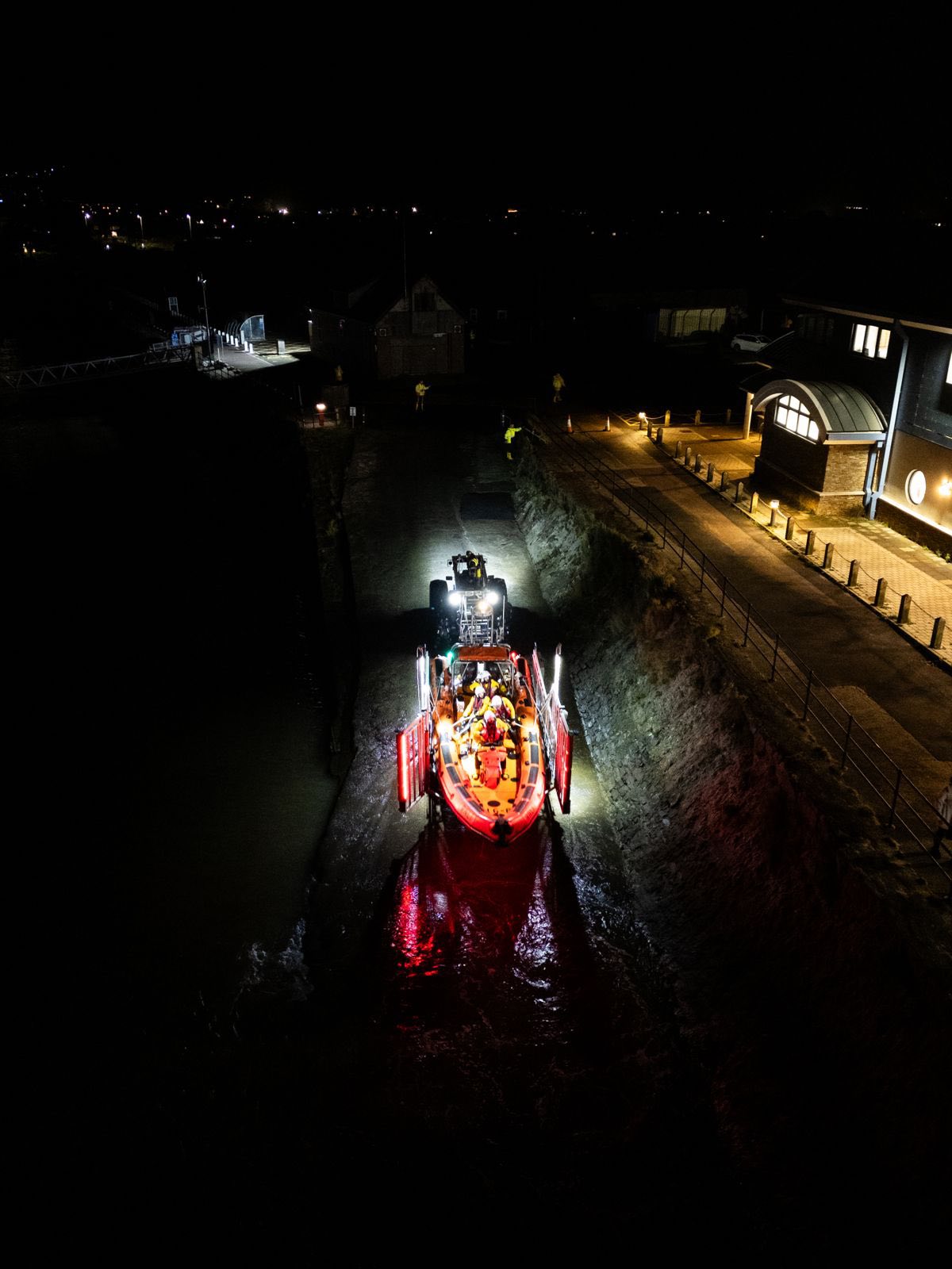 D class lifeboat photo taken from drone above as it goes down slipway in the dark