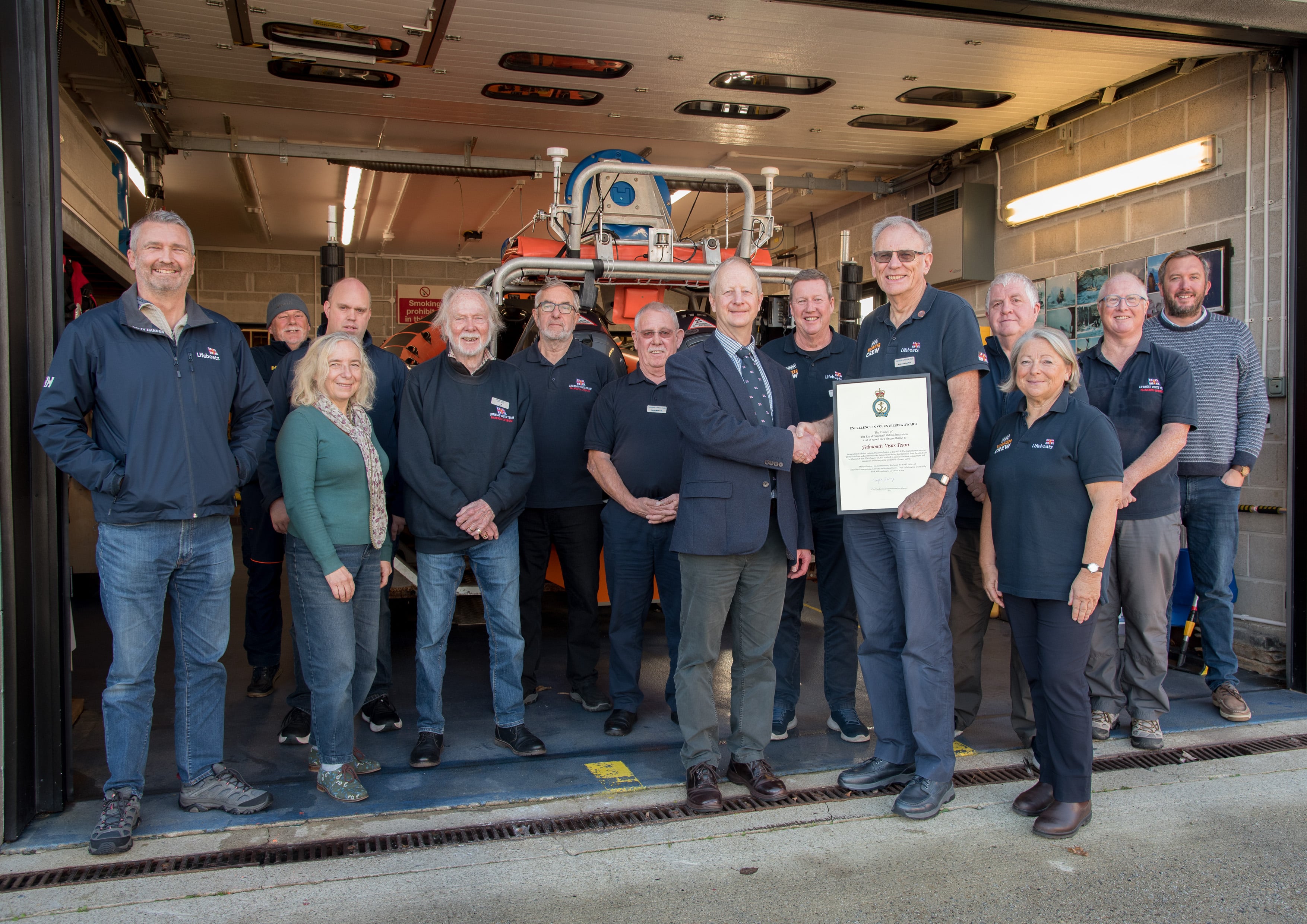 Adrian Carey, RNLI Head of South West Region and Falmouth RNLI Visits Officer Andrew Mumford with members of Falmouth RNLI Visits Team and Falmouth Coxswain Luke Wills (far right) and ALB Mechanic Andy Edwards and Senior Station Technician Jon Blakeston (far left and behind).
