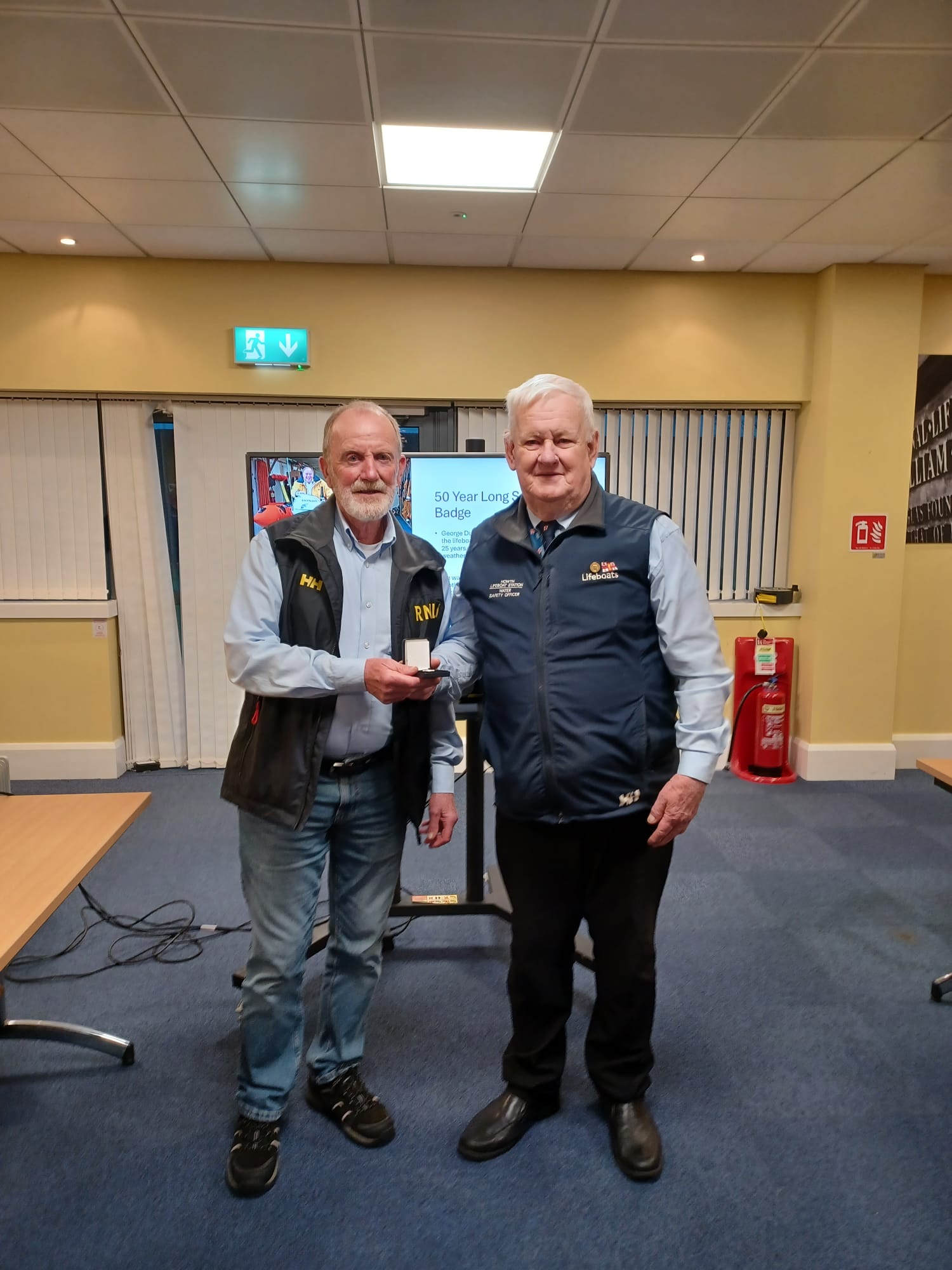 George Duffy pictured with his 50-year Long Service Award, a badge, presented by John McKenna.
