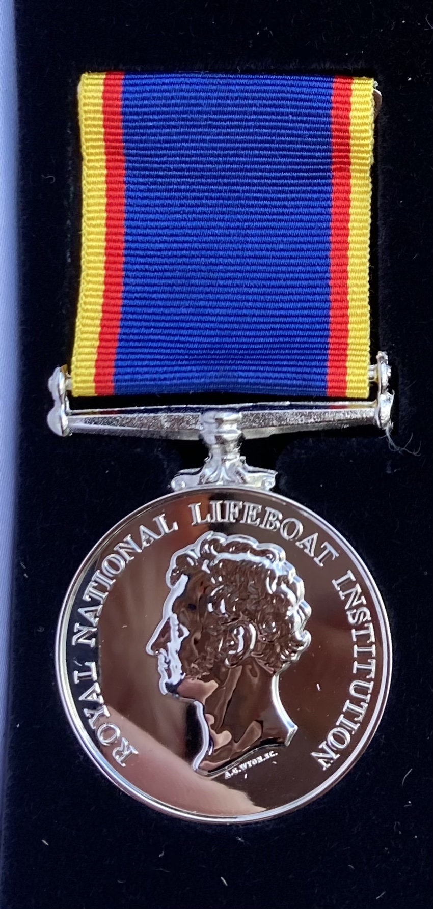 Silver medal with ribbon