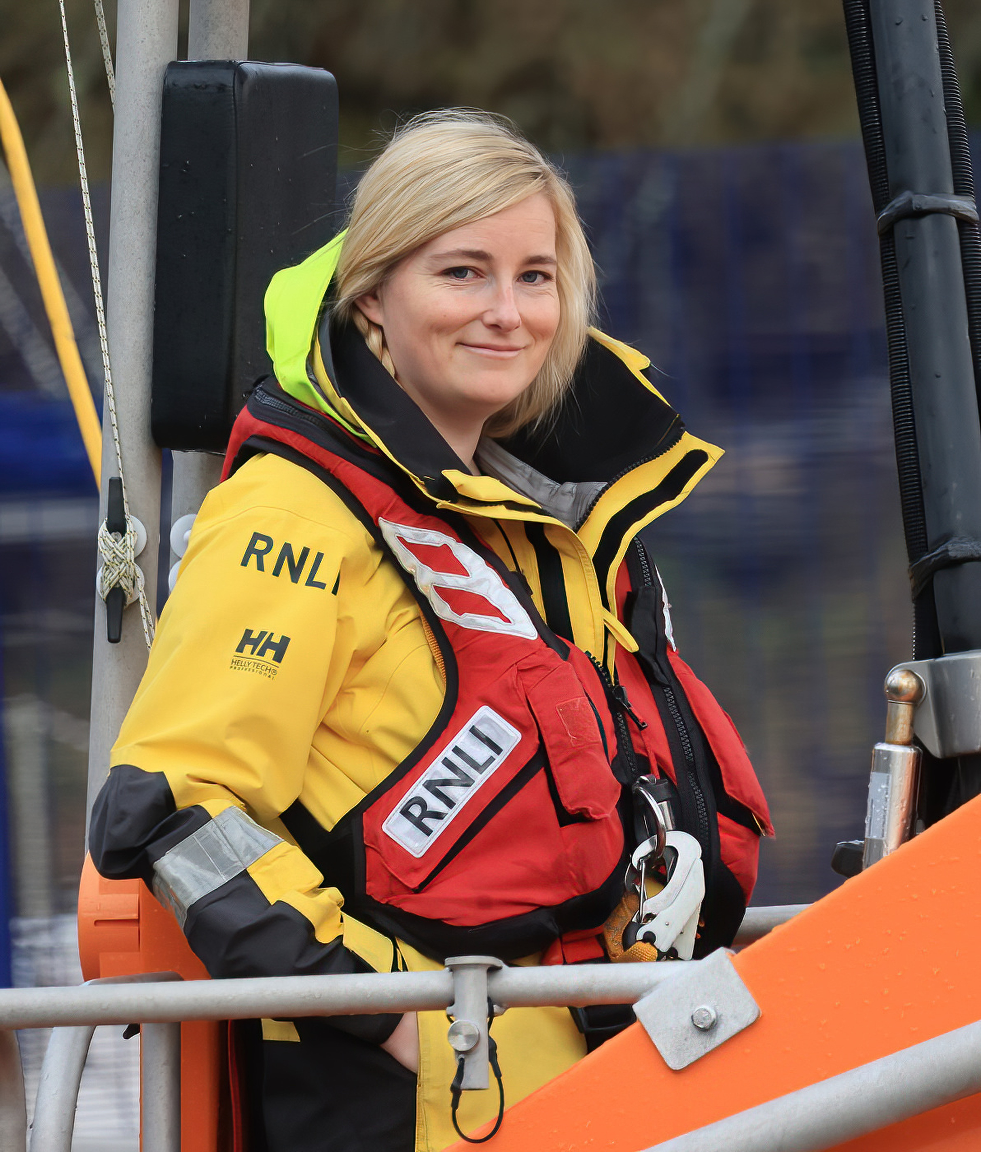 Leonie Woolf in her full seagoing yellows and lifejacket poses for a photo on the upper bridge of the Shannon class lifeboat
