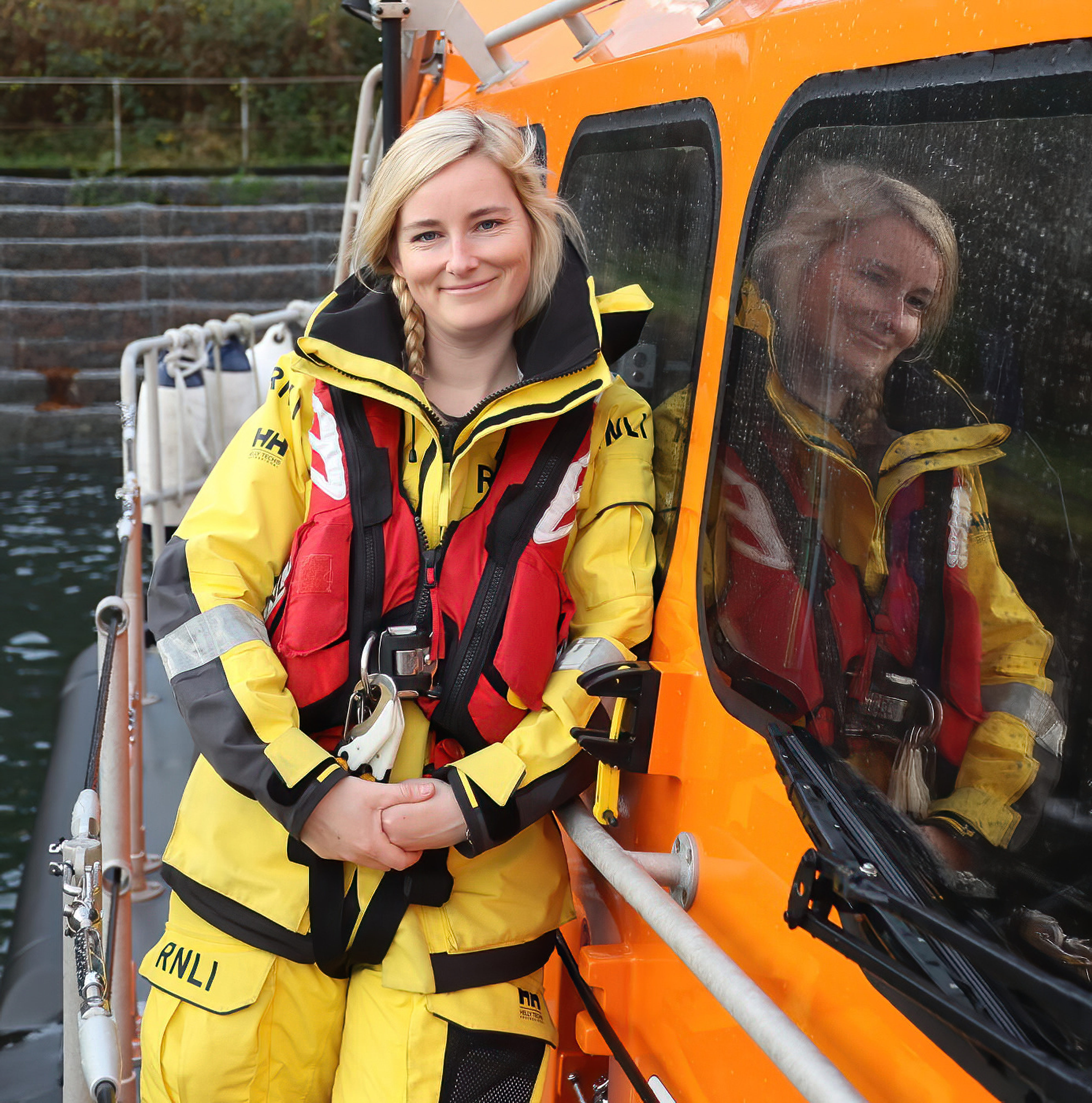 Leonie Woolf in her full seagoing yellows and lifejacket poses for a photo on the Oban's Shannon class lifeboat