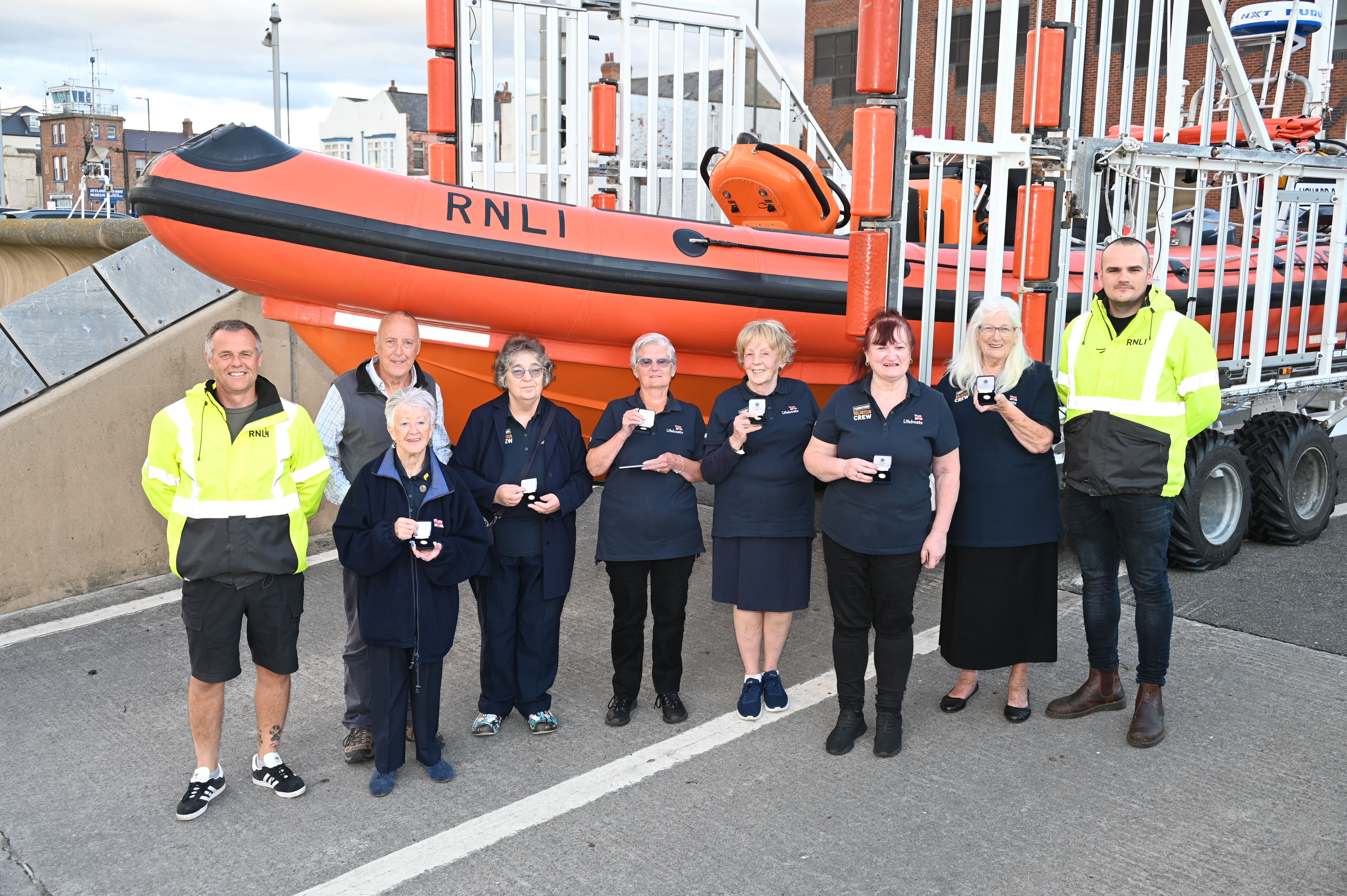 Redcar RNLI Lifeboat Operations Manager Mike Picknett, Chairman Dave Cocks and senior Helm Nathan Hobday with theLadies Guild members