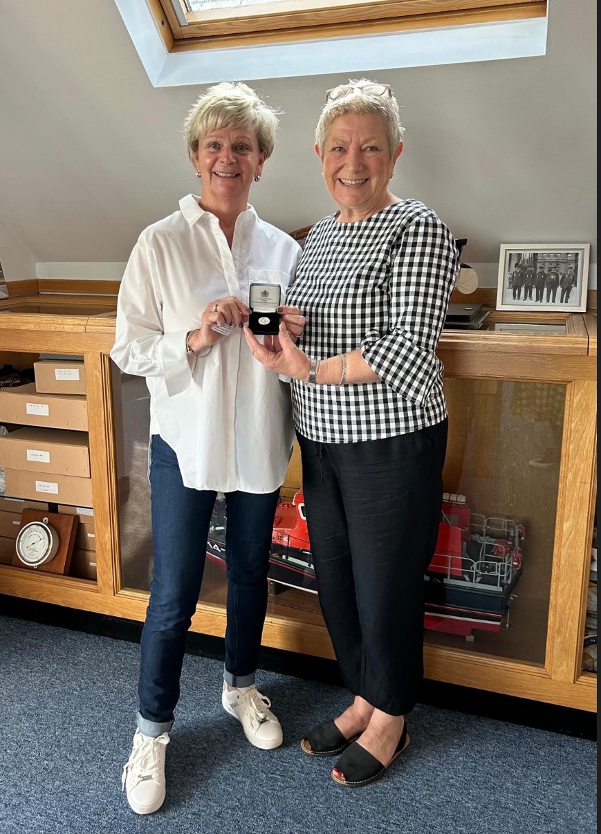 Barbara Beales (L) accepting her 20 year long service award from Guild Vice Chair Frances Mobbs