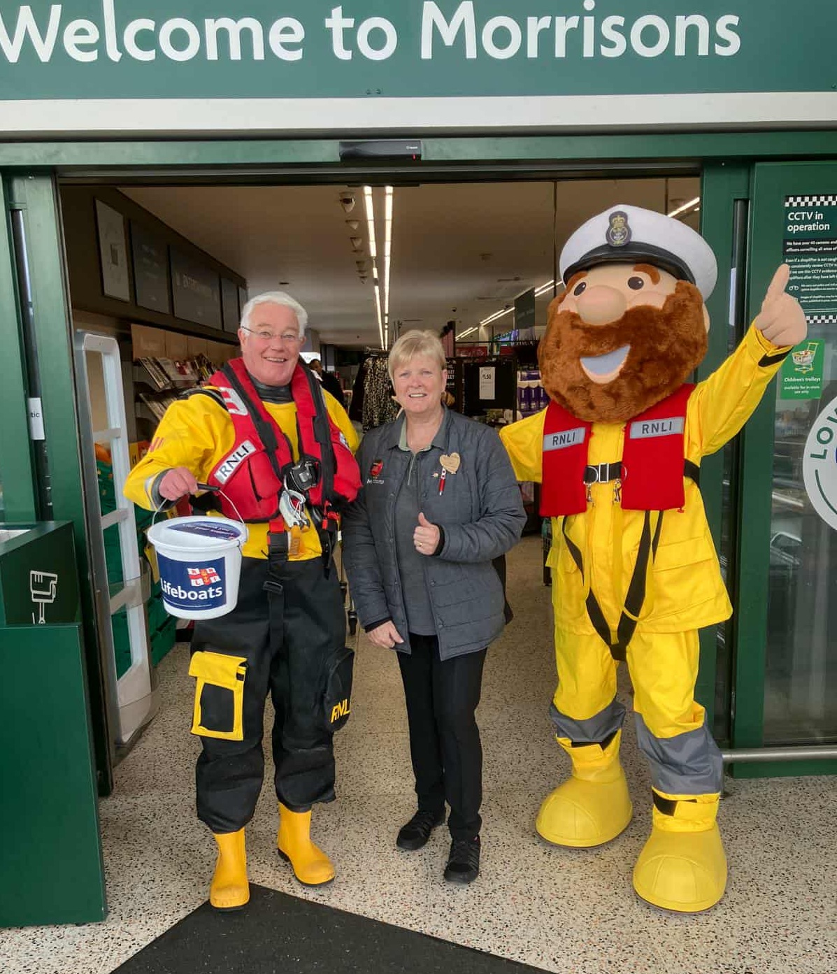 RNLI stations manager with mascot Stormy Stan collecting at Morrisons with store assistant Liz