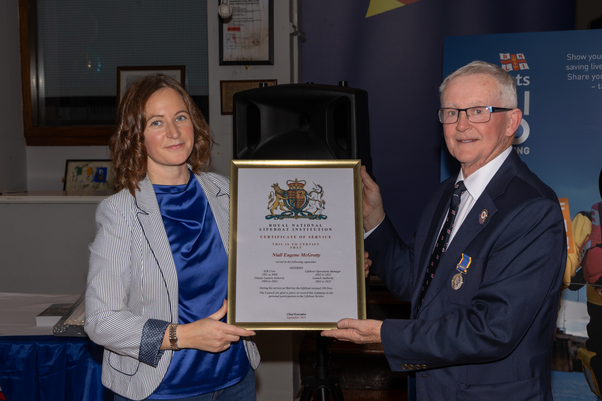 Area operations manager Lisa Hollingum presenting Niall McGrotty with his certificate of service.