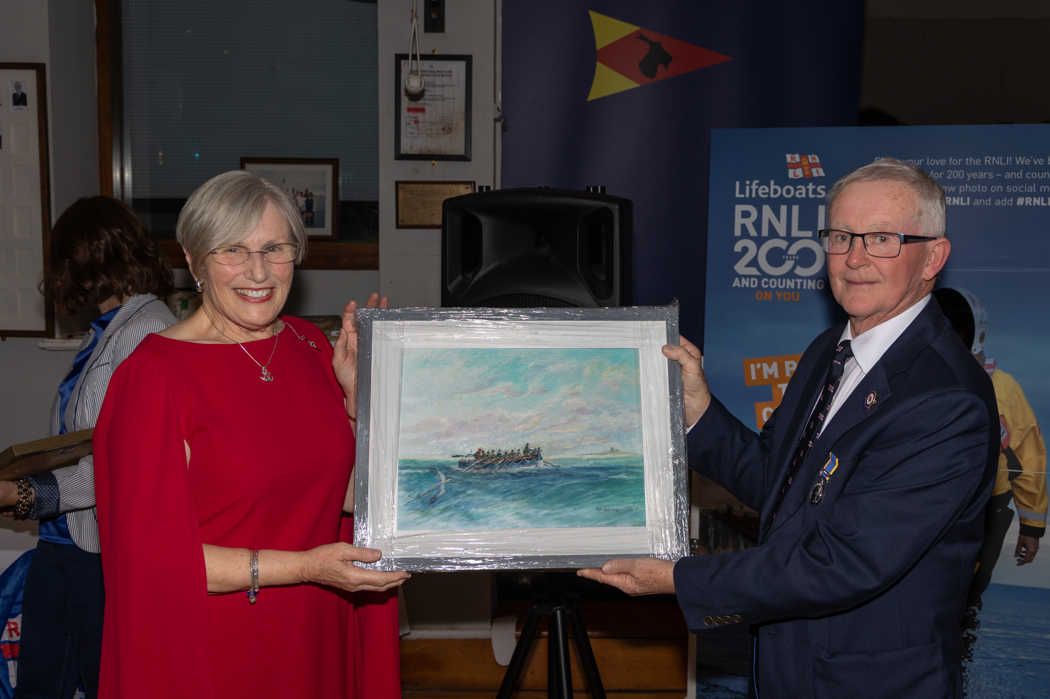Kalanne O'Leary presenting Niall McGrotty with a painting by Hugh Ryan