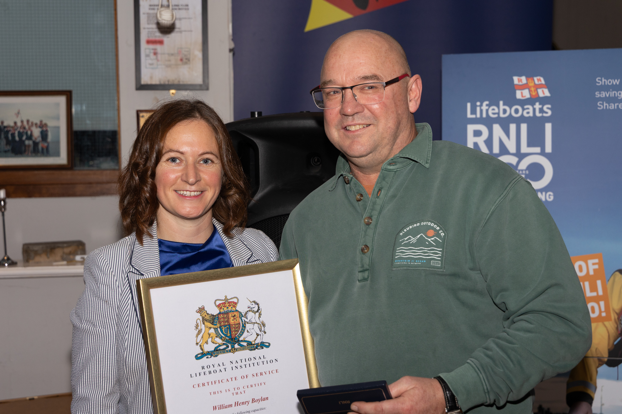 Area operations manager Lisa Hollingum presenting Willie Boylan with his certificate of thanks and long service medal.