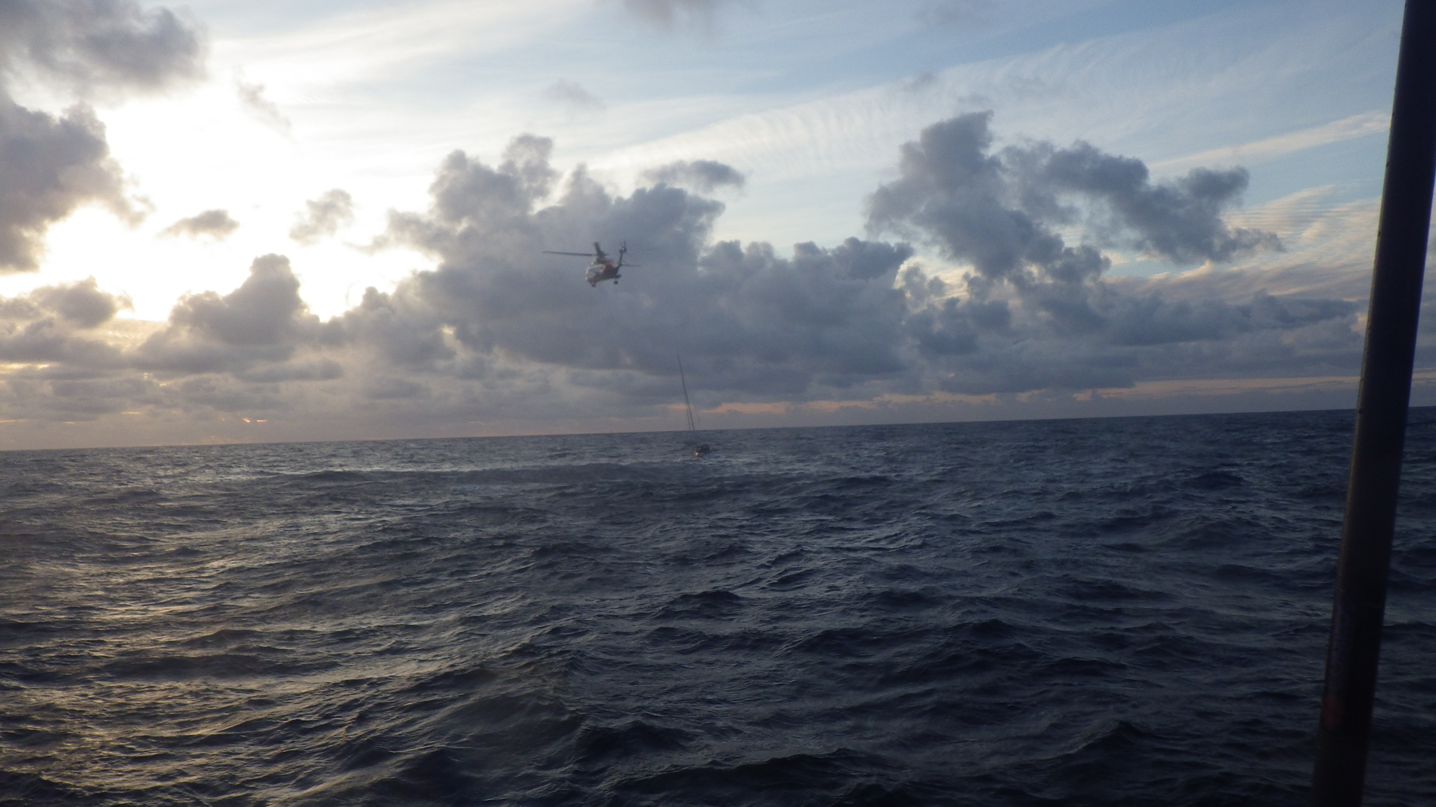 Helicopter hovering above yacht