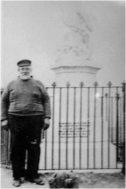 Captain Thos. Kew and the Eliza Adams Memorial. Man stood in front of the lifeboat disaster memorial Wells