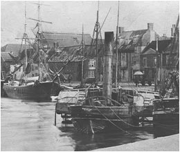 The steam tug Promise at Wells circa 1880. Black and White photograph of Steam tug in quayside with other boats and buildings in the backround