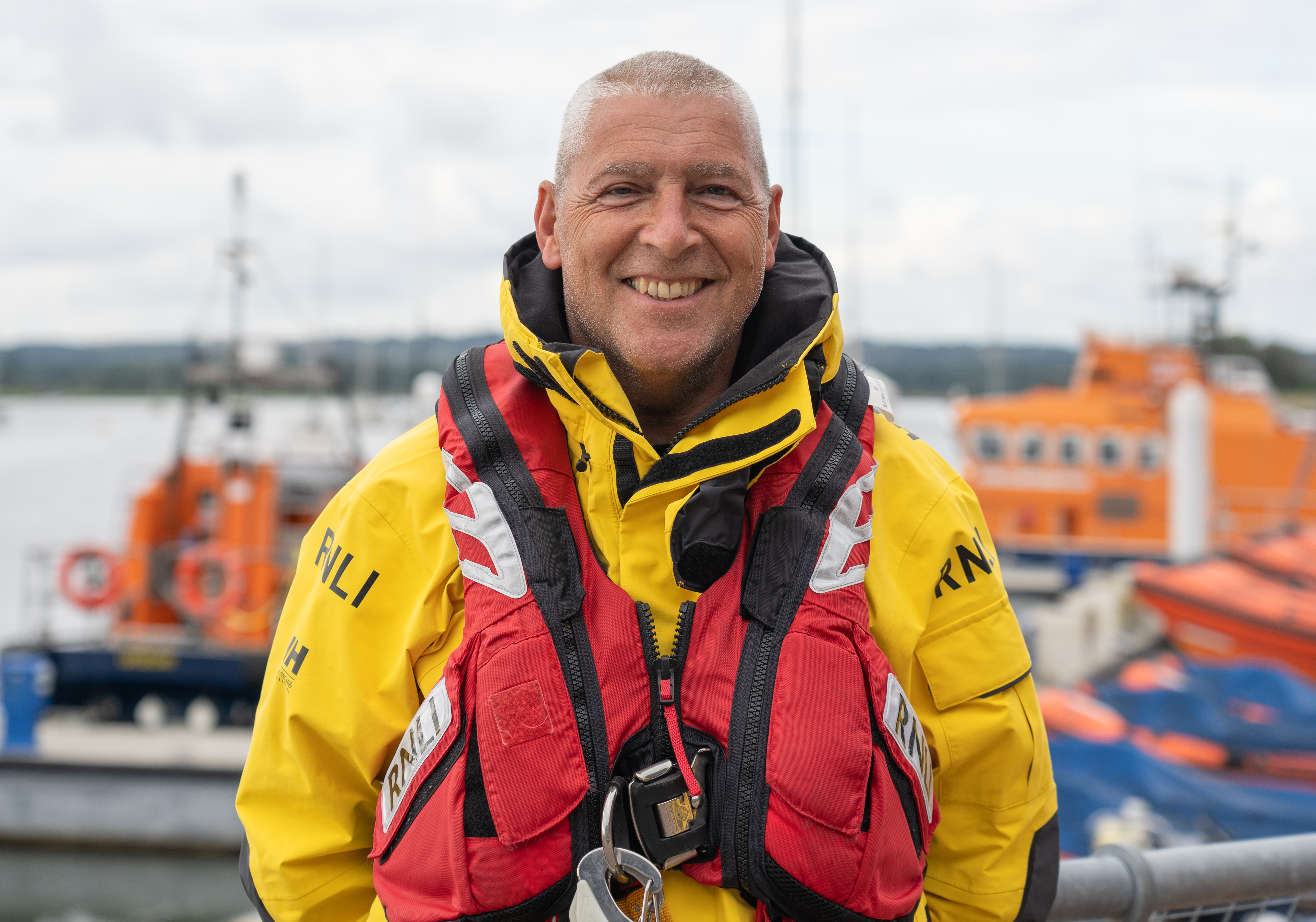 Rod Wells stands on the quayside in his all-weather lifeboat kit at the RNLI headquarters in Poole