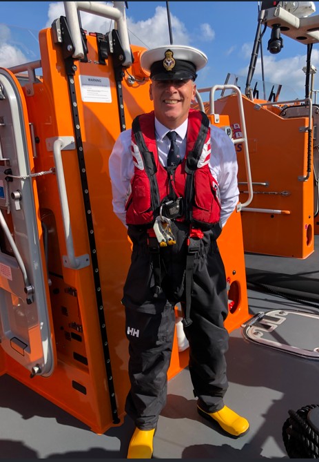 Rod Wells stands proudly onboard the RNLI's first Legacy Lifeboat 'George and Frances Phelon' on her arrival day at Great Yarmouth and Gorleston