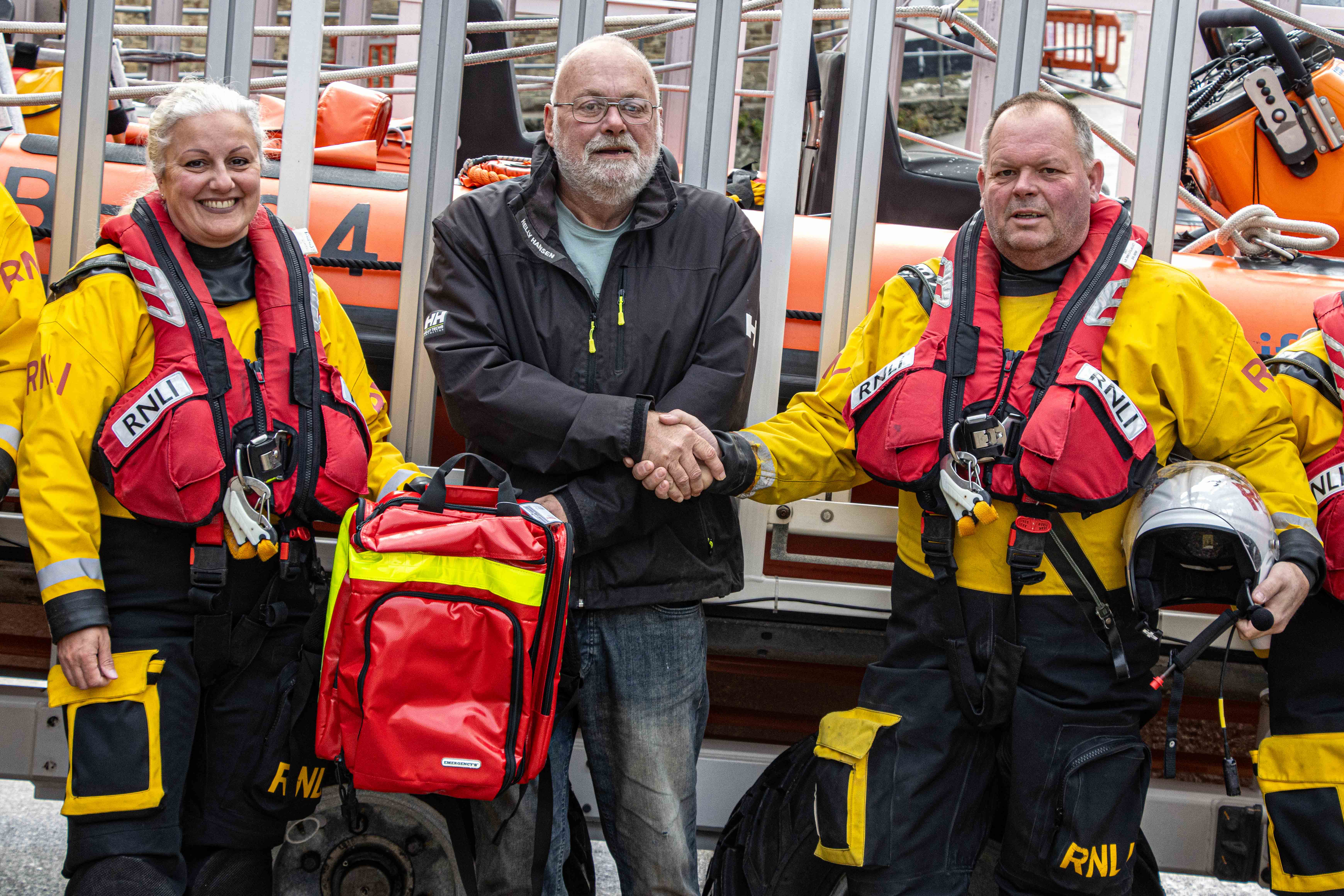 Looe RNLI’s Lifeboat Operations Manager Clive Palfrey and crew member Victoria Thomas thanking Richard Davies