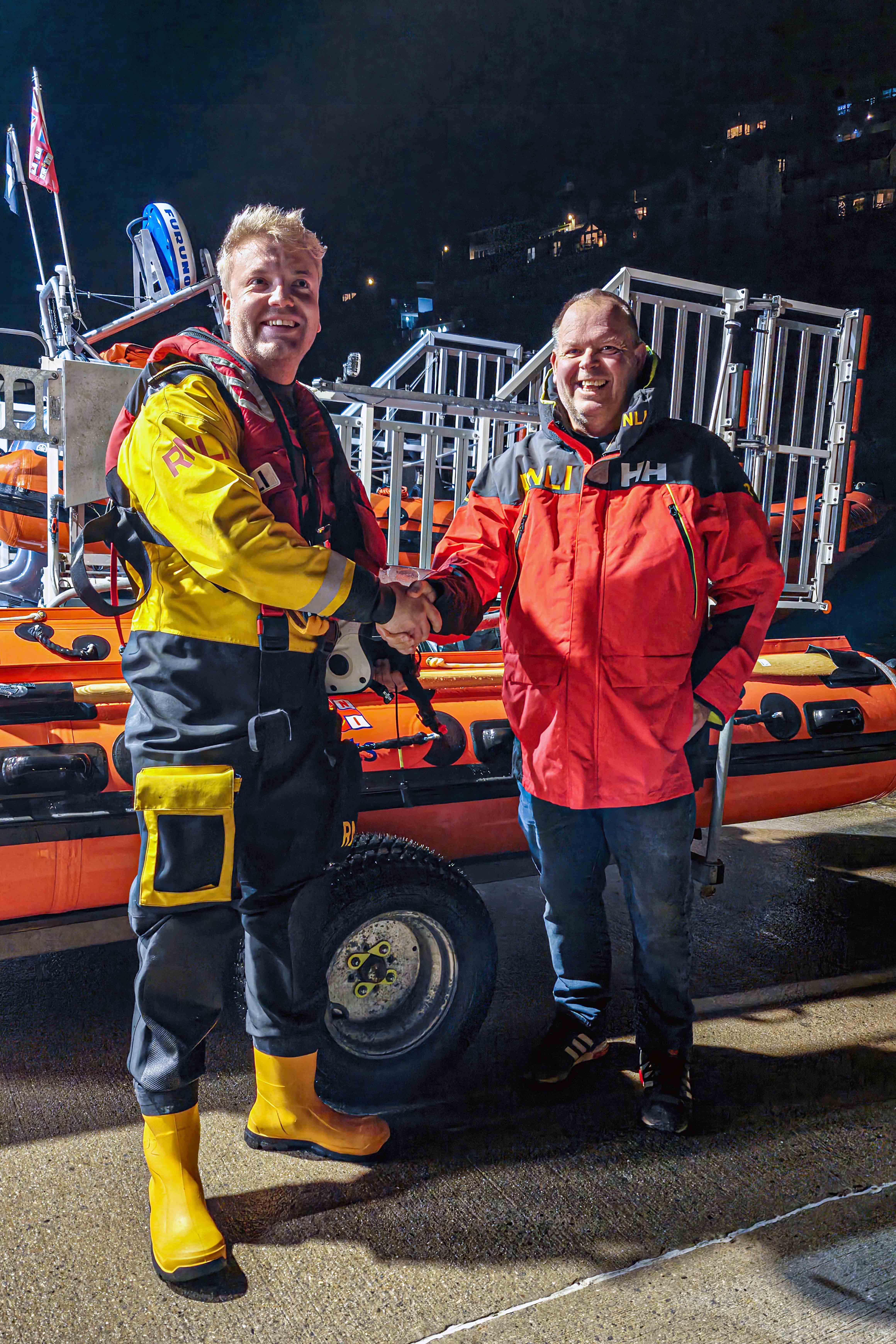 Looe RNLI’s Lifeboat Operations Manager Clive Palfrey congratulating Looe RNLI’s latest helm, Goron Jones