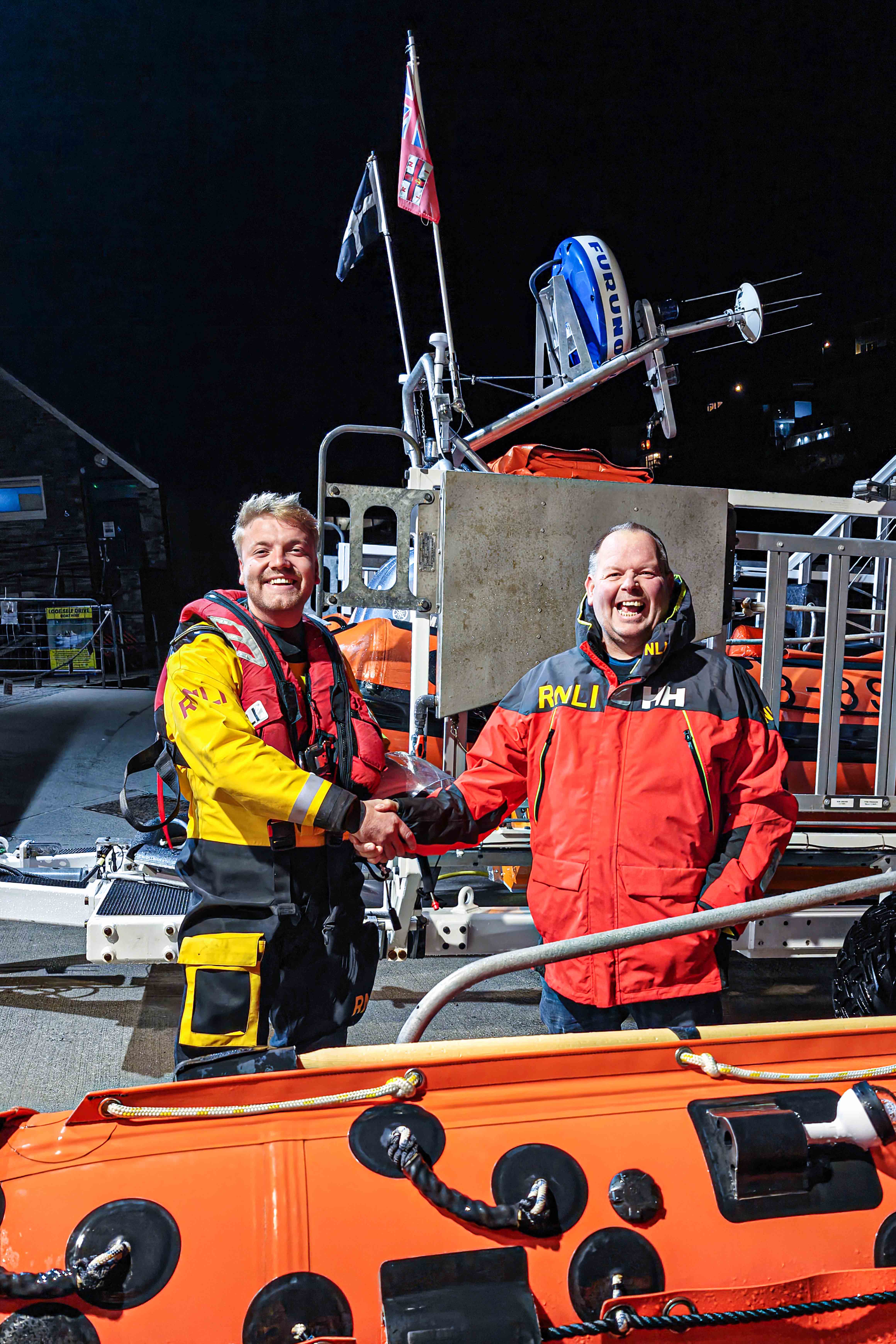 Looe RNLI’s Lifeboat Operations Manager Clive Palfrey congratulating Looe RNLI’s latest helm, Goron Jones