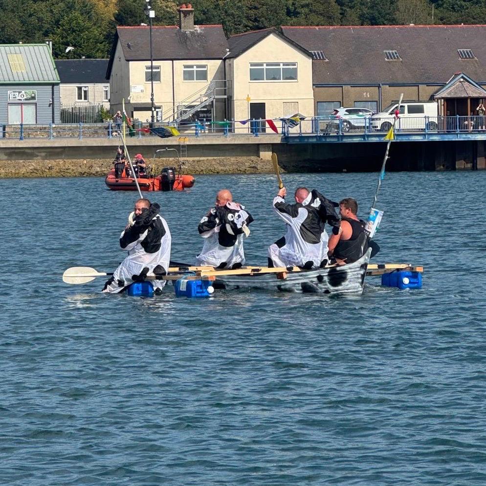 Charity Raft Race entrants having fun on the water on a home build raft