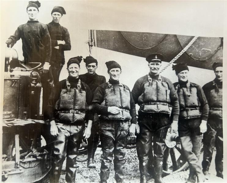 Balck and white photograph of Wells RNLI crew and lifeboat wearing cork lifejackets