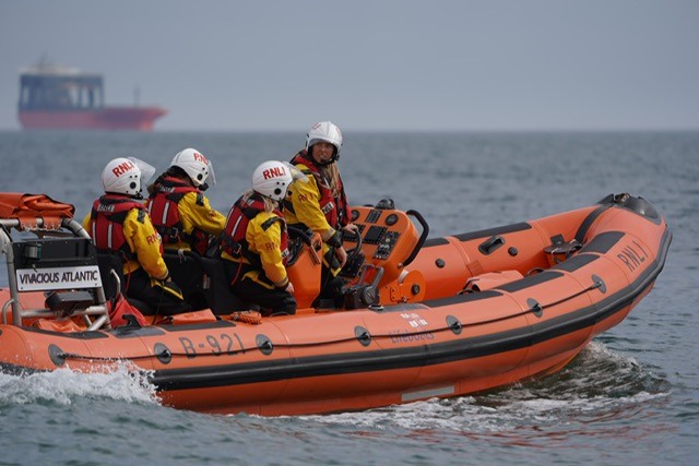 A lifeboat with four crew onboard in calm seas