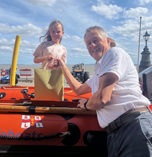 Grace Irish being presented with her prize by Phil Lay Penarth LOM whilst sat on the D-Class in front of the station