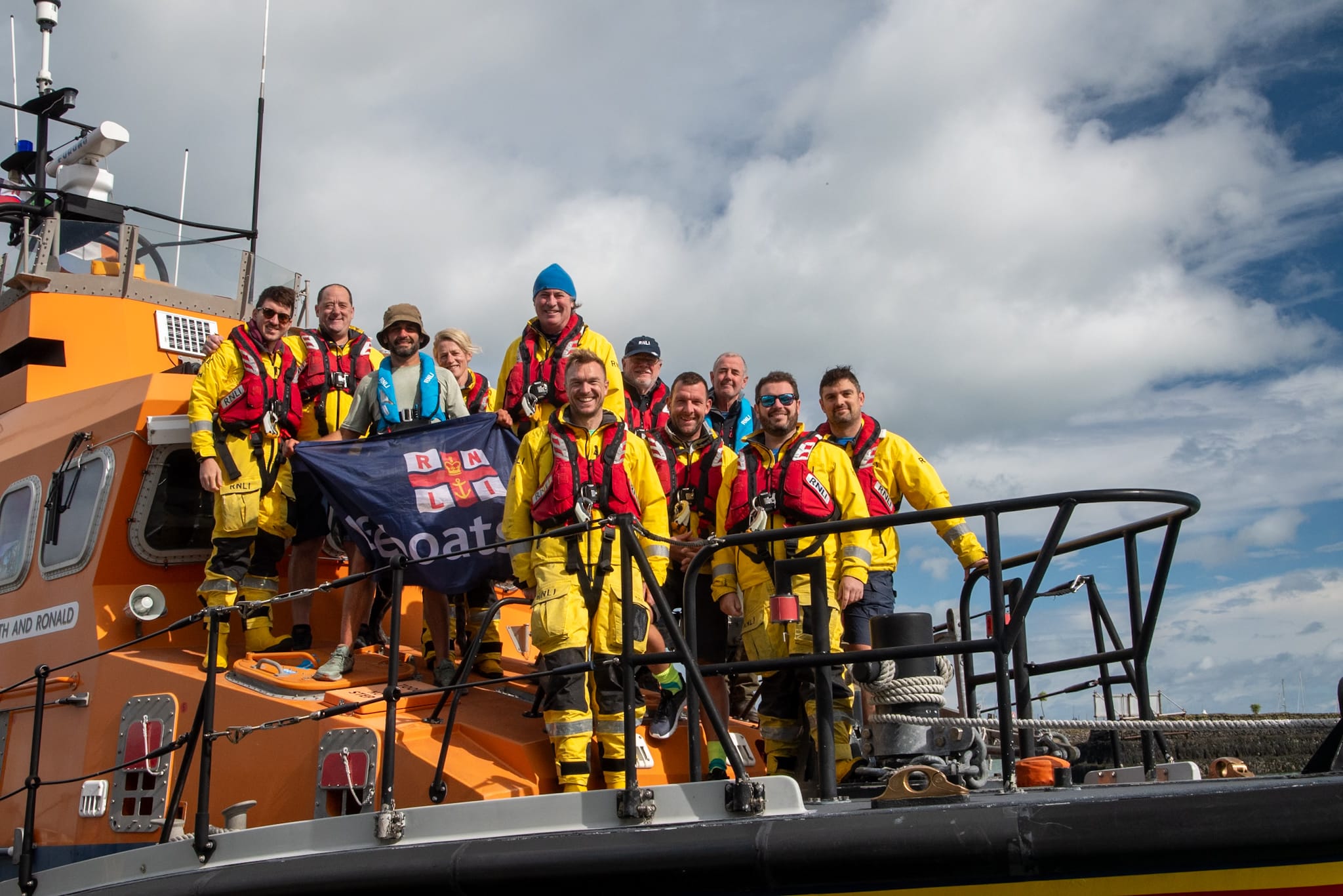 Endurance runner Vini Cardoso on board the Howth All-Weather Lifeboat with the volunteer crew of Howth RNLI after he returned to Howth completing his 6 week coastal running challenge.