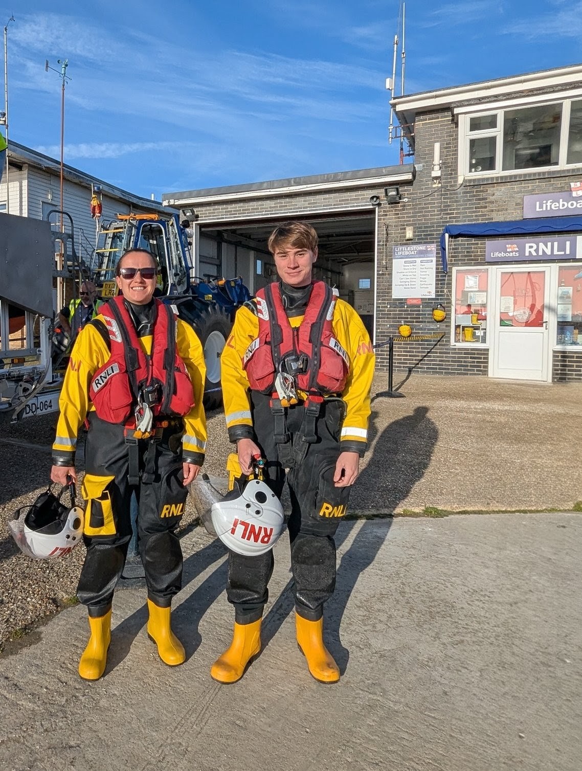 Sam and Mihaela in full RNLI yellow and black drysuits and red life jackets before they went afloat together .