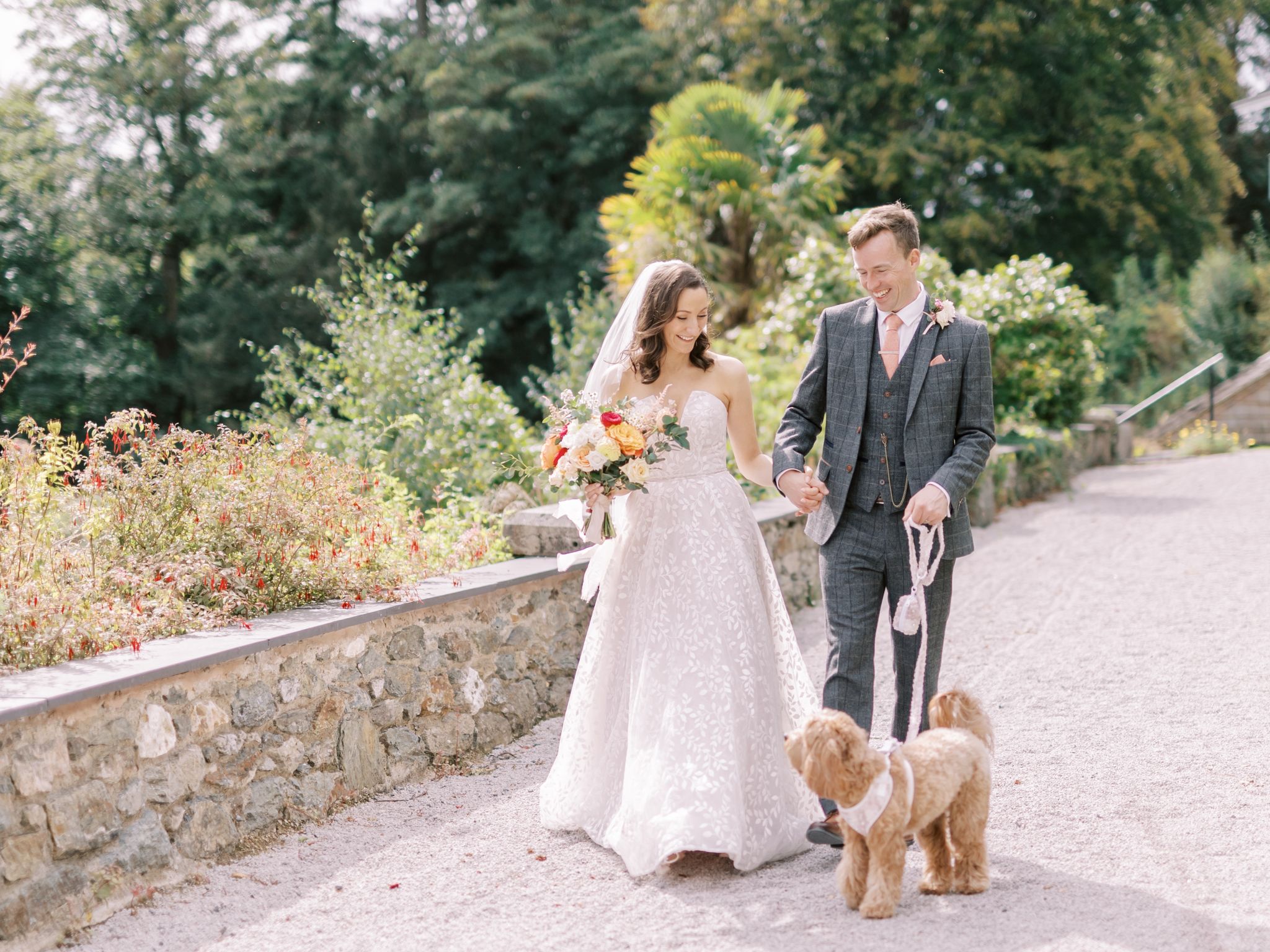 The couple walk along with their dog on a lead next to them, Daisy. 