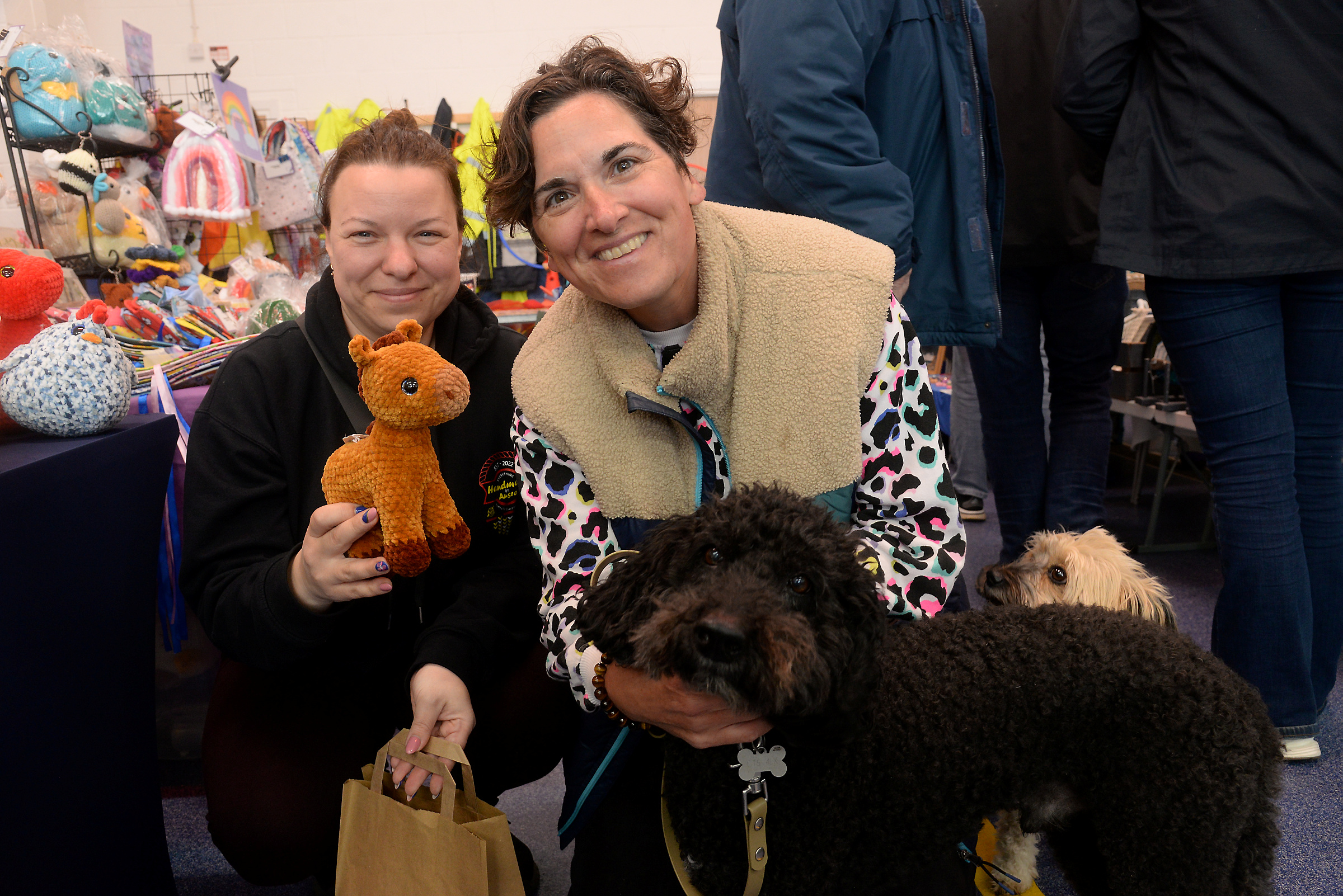 Nicole Yost and her dogs Dudley and Ruby make a purchase from Ausra Radaviciene at the Whitstable RNLI Easter Fair on Good Friday.
