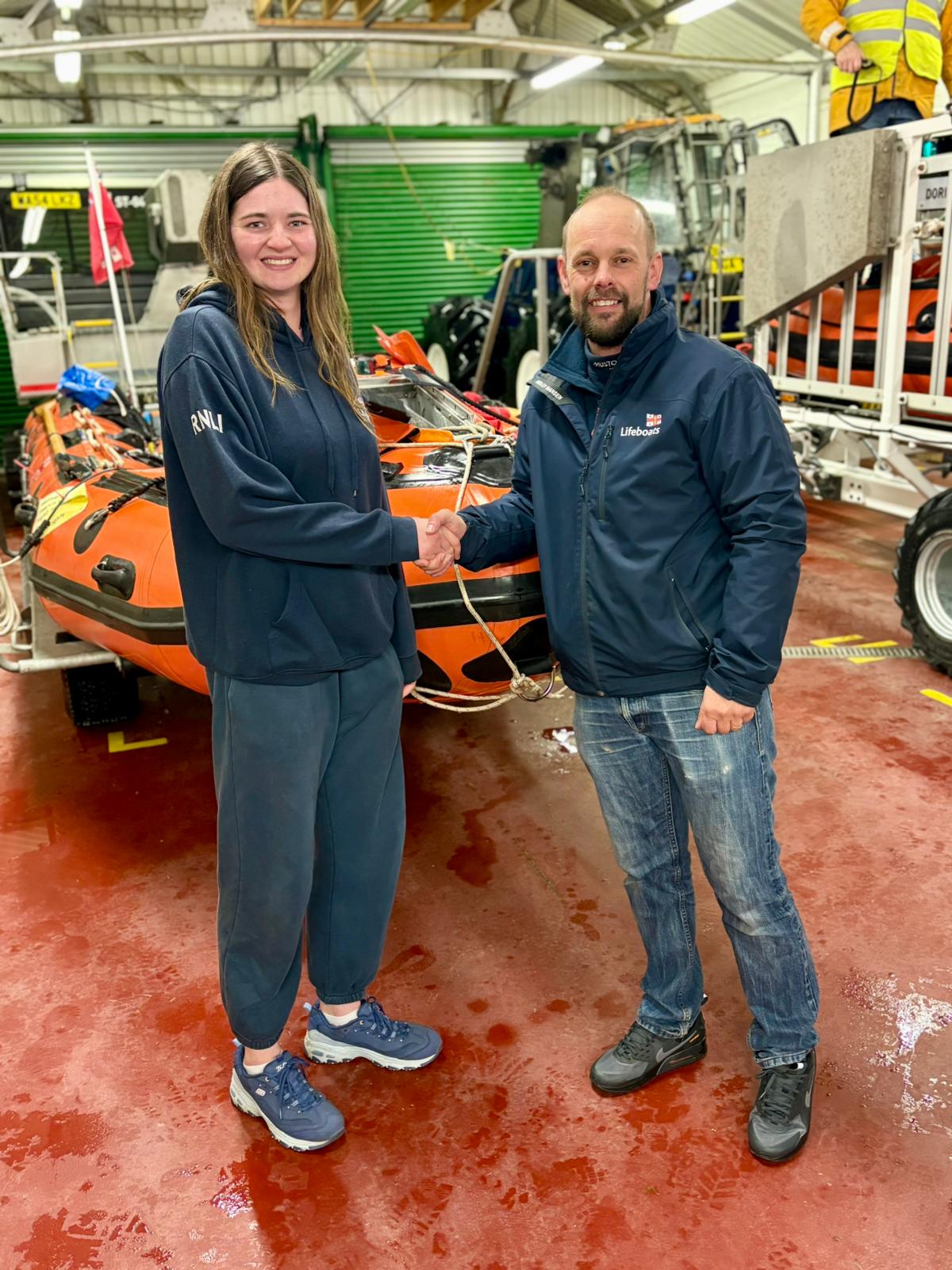Megan as she is being congratulated by Senior helm/ assessor Jason Coombes.