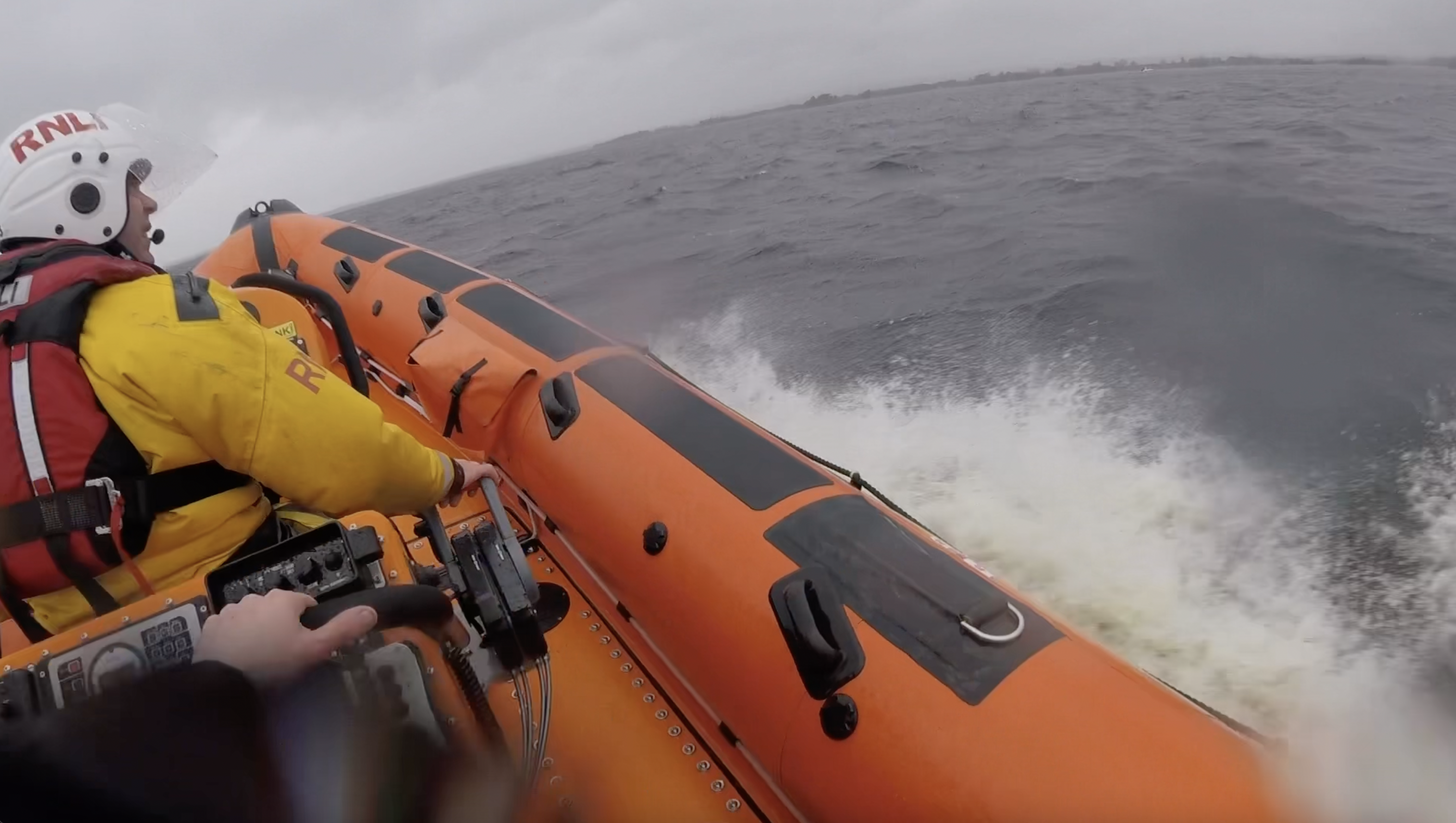 View over the starboard bow of the lifeboat with the helm in view