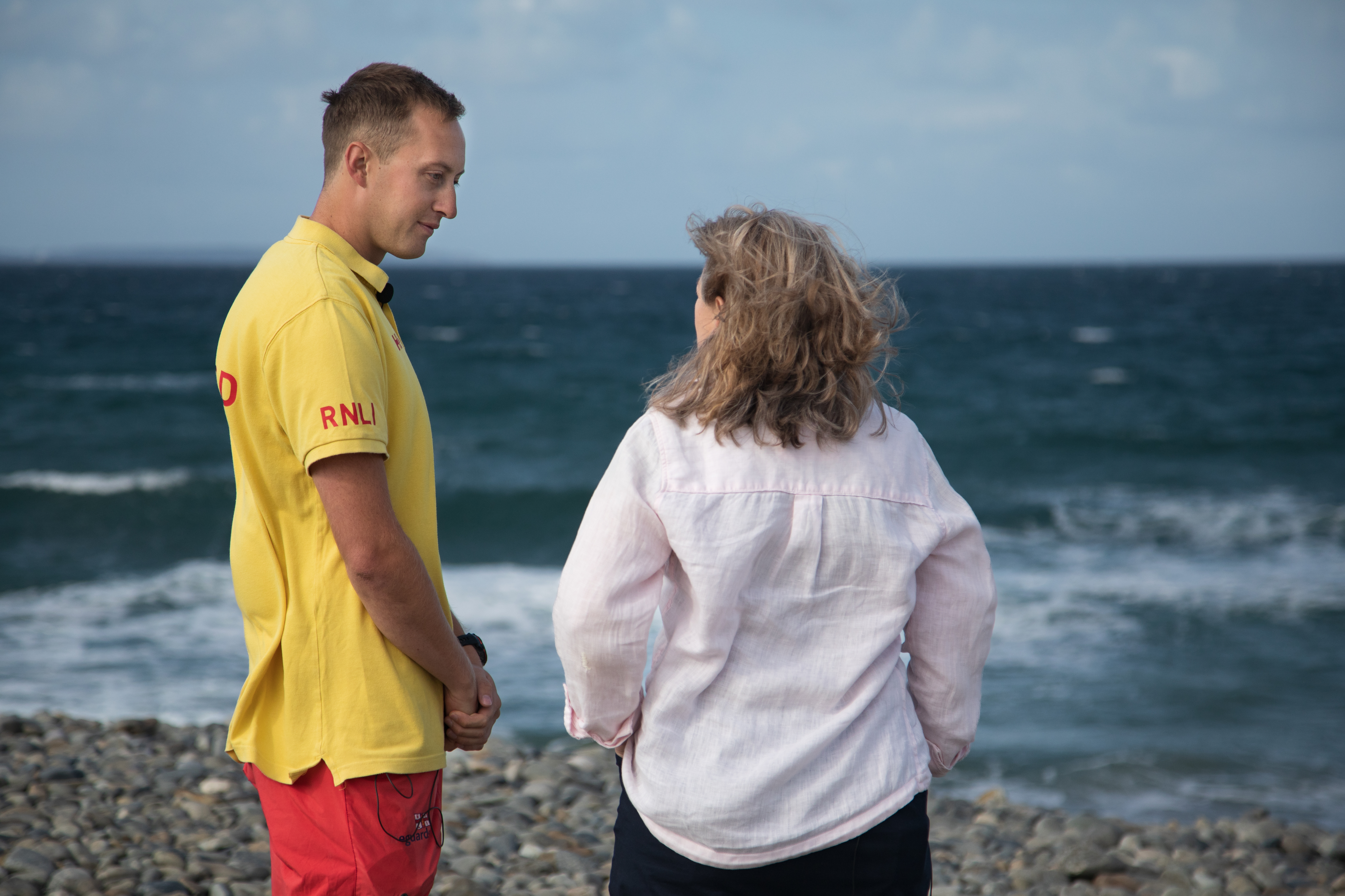 Landscape image of Matty and Joanna facing the sea. 
