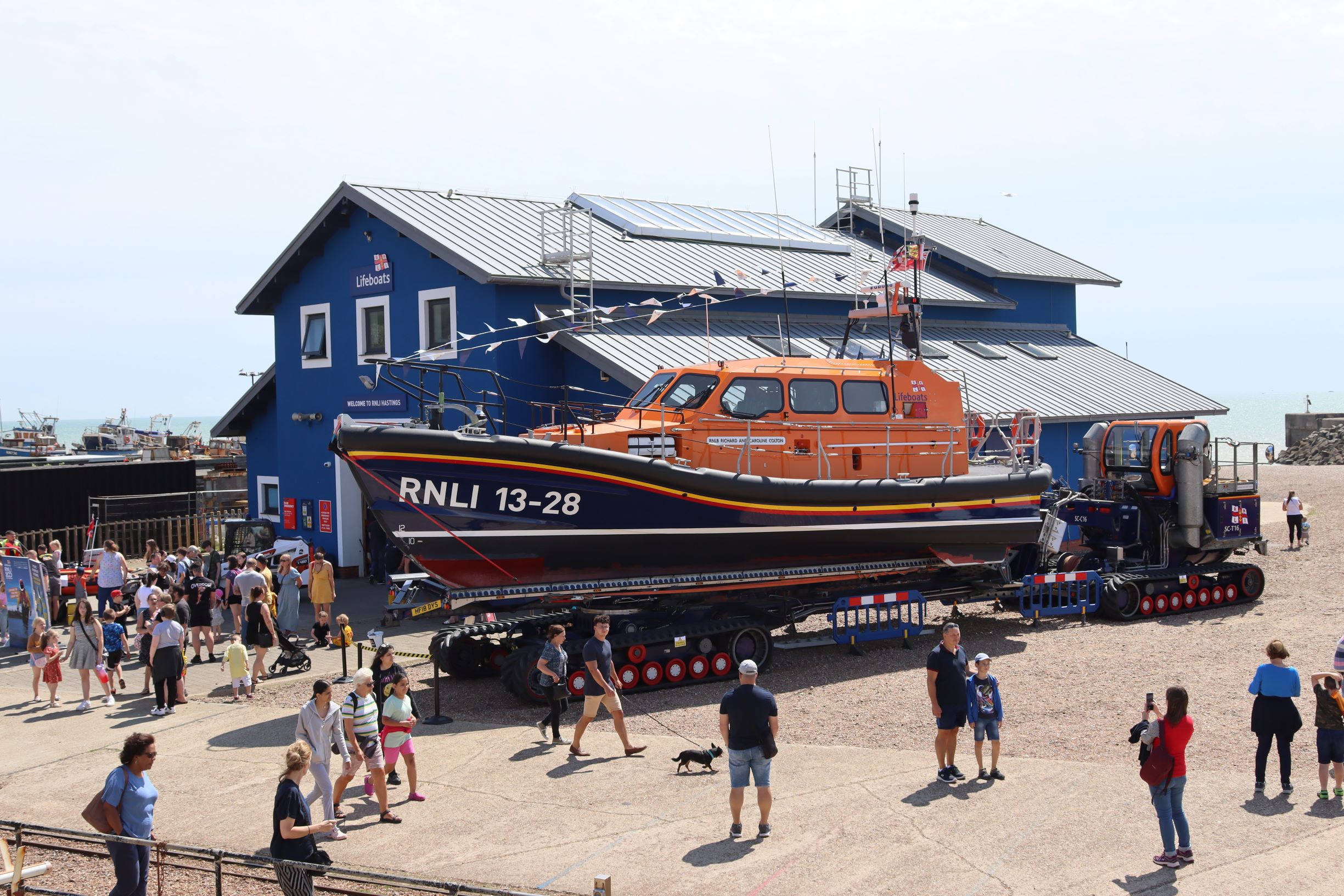 criowds enjoy sunshine outside of Hastings lifeboat station
