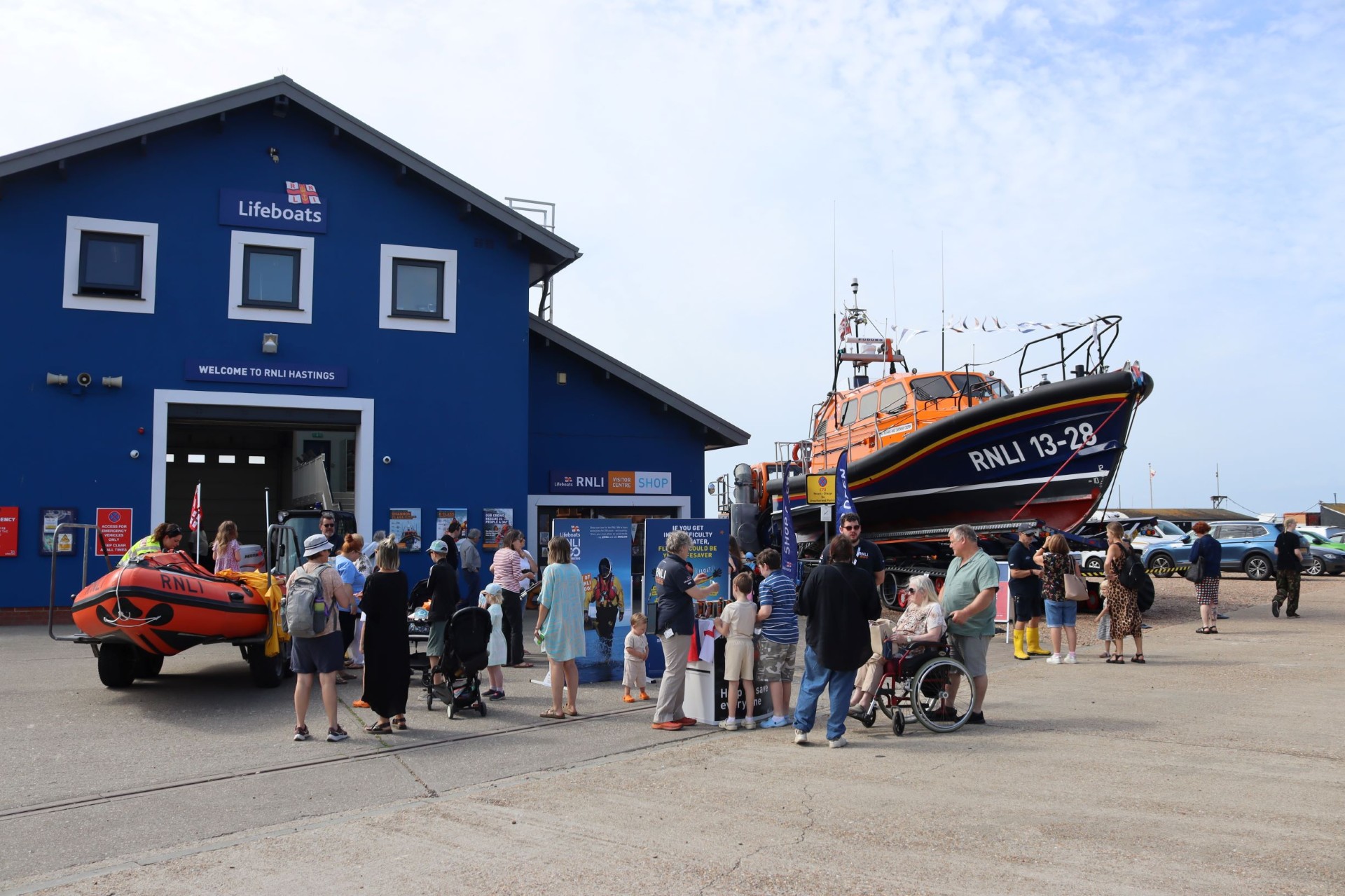 Crowds in front of Hastings lifeboat station looking at lifeboats