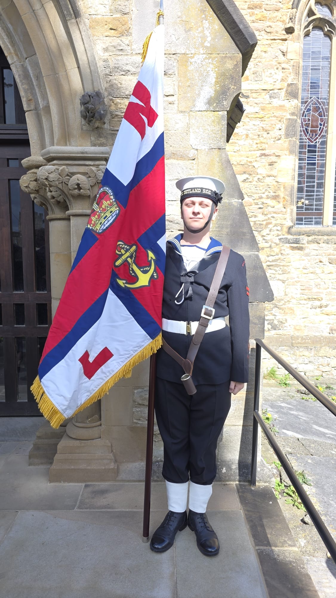 Redcar Sea Cadet carries the RNLI Standard at Lord Zealand's memorial service