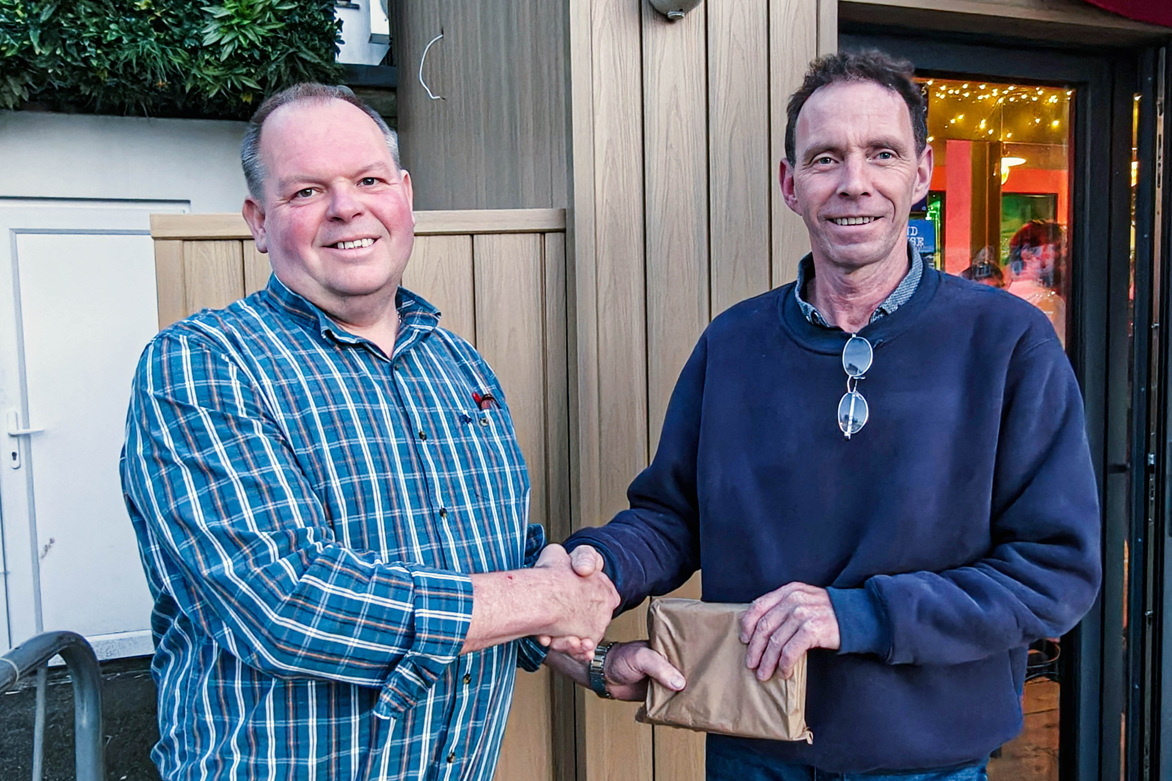 Looe RNLI’s Lifeboat Operations Manager, Clive Palfrey (left) presenting Brian Bowdler (right) with a retirement gift from the crew at Looe Lifeboat Station
