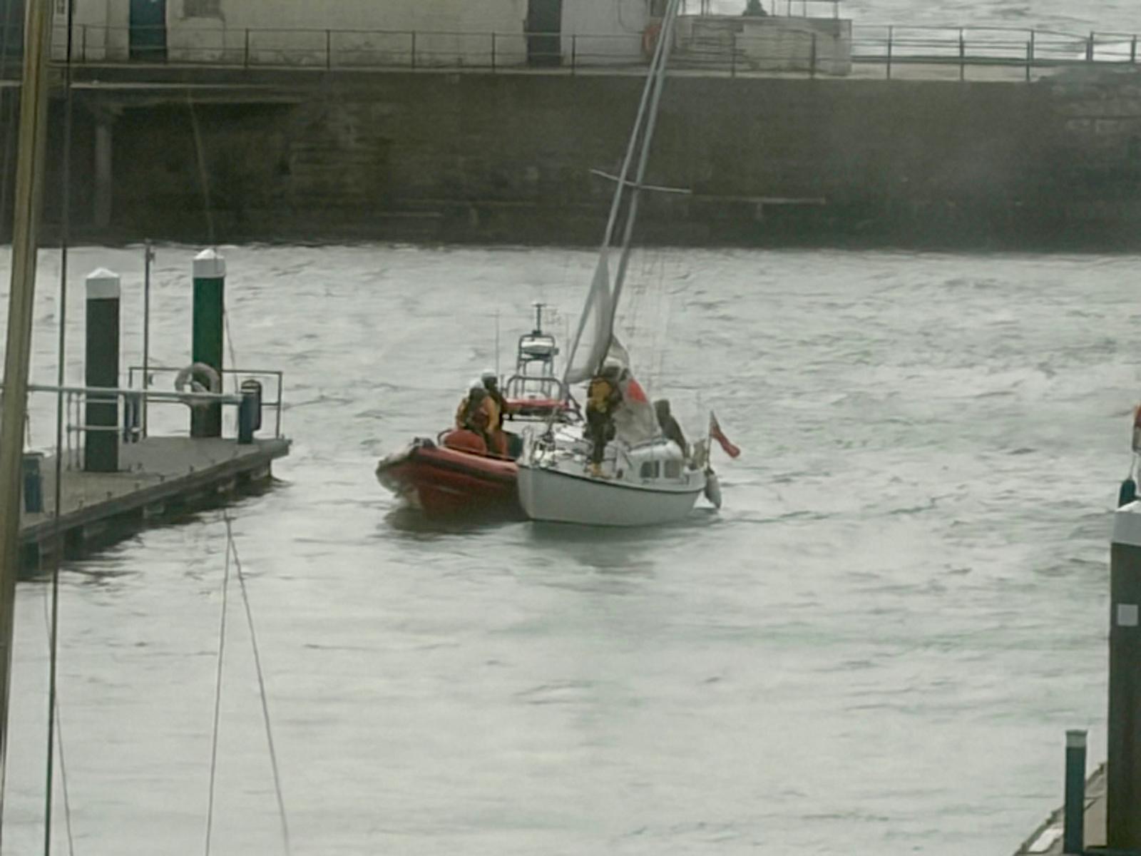 Walmer Atlantic 85 lifeboat towing vessel in harbour inside harbour wall grey skies and seas