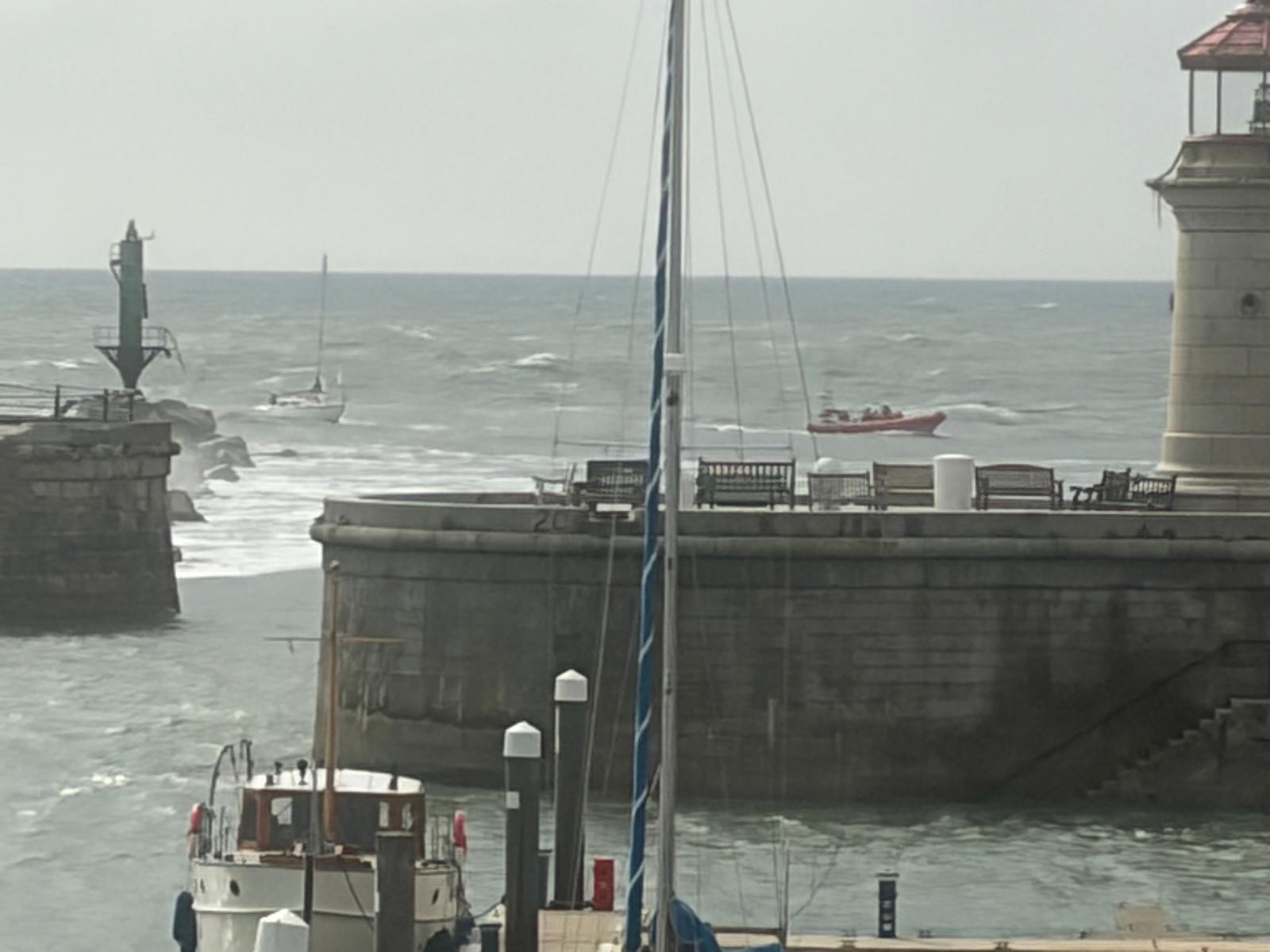 Walmer Atlantic 85 lifeboat towing vessel in harbour inside harbour wall grey skies and seas
