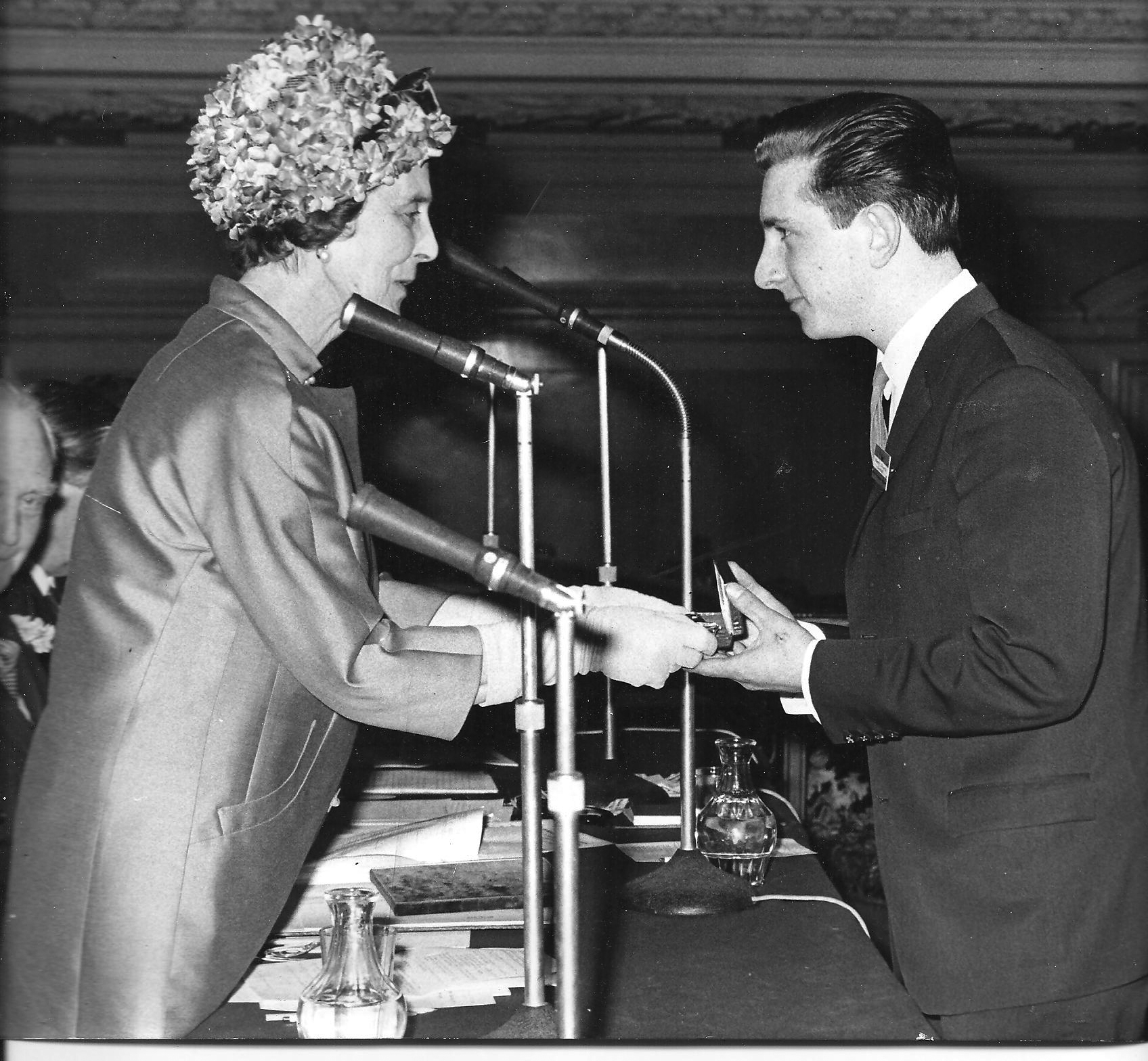 Man receives award from woman.