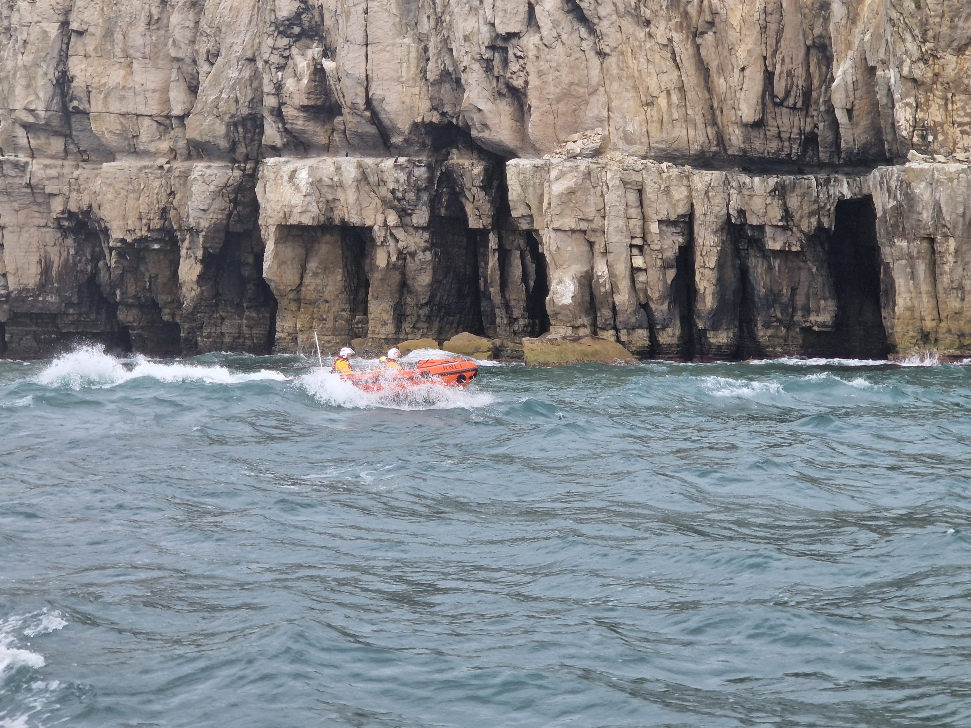 Swanage ILB passing the cliffs to the west of Swanage Lifeboat Station