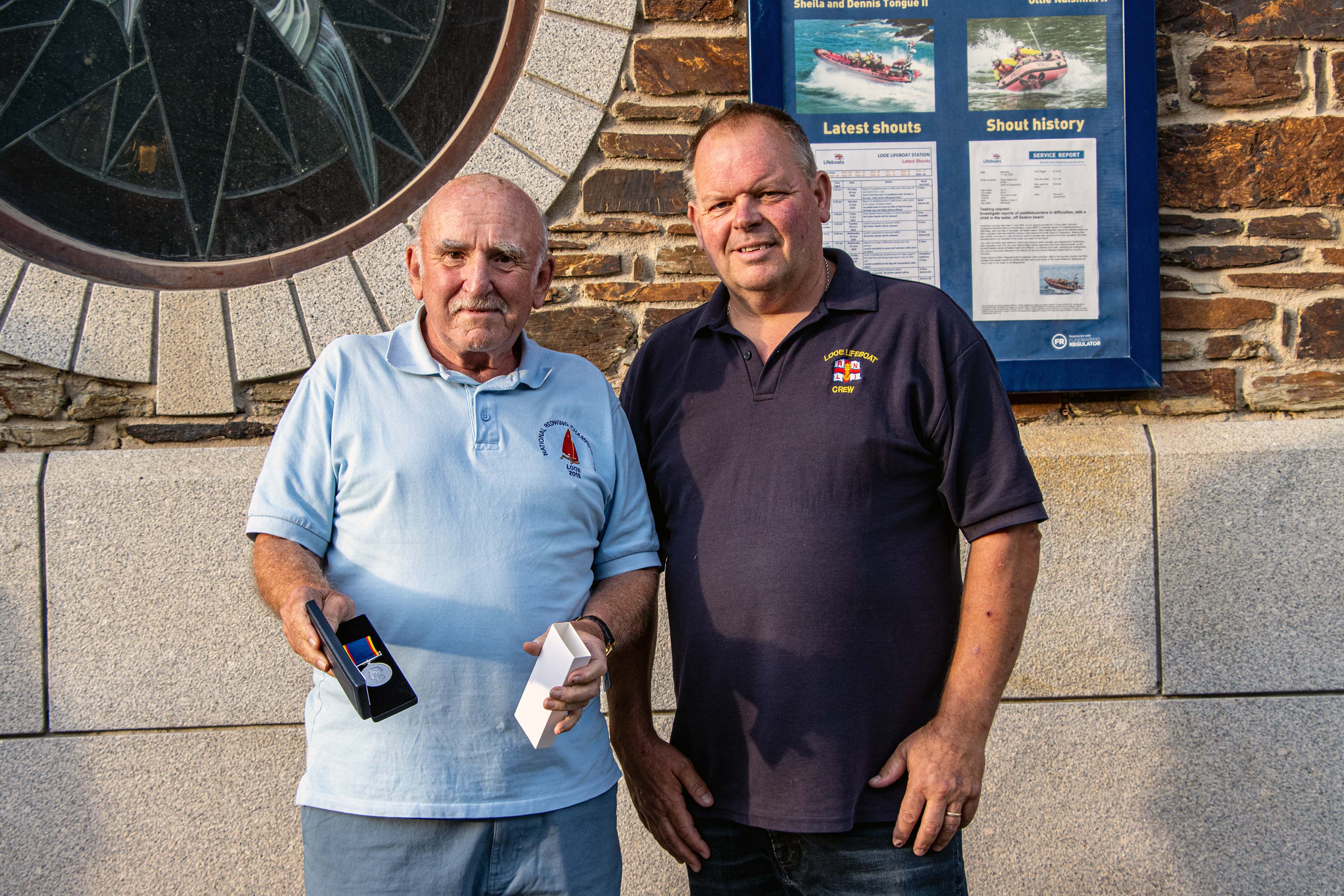 Looe RNLI Lifeboat Operations Manager Clive Palfrey presenting Paul Sedgbeer with his 20 year long service medal