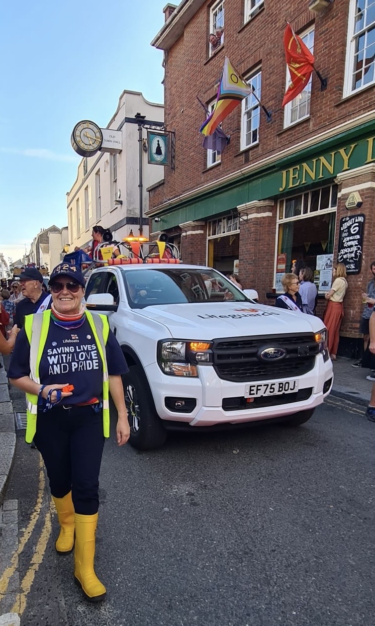 volunteer marshall leading lifeguard truck in carnival