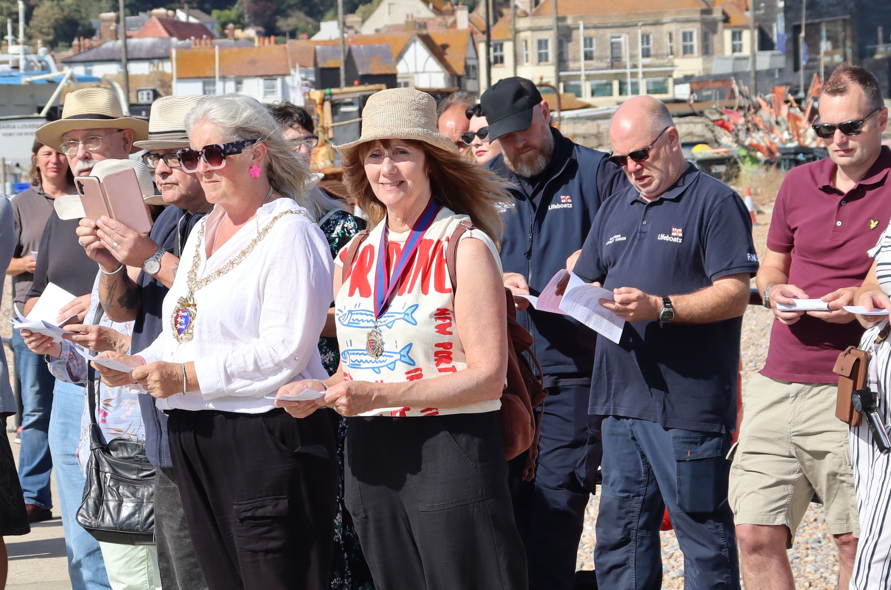 The mayor and deputy mayor, and RNLI crew, standing on the harbour arm