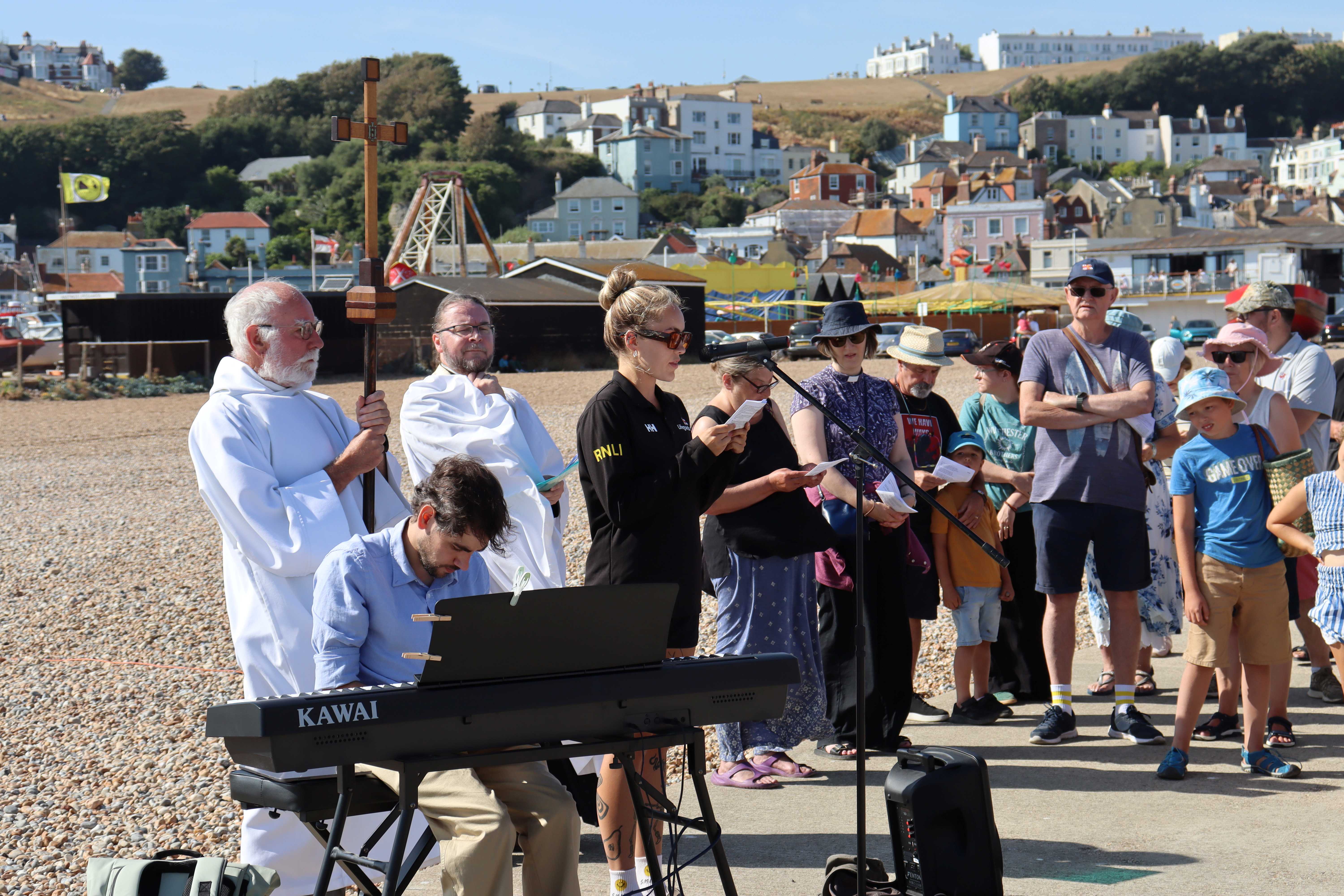 Nelly Gallichan lead lifeguard supervisor, reads a lesson alongside the rector, crucifer and organist
