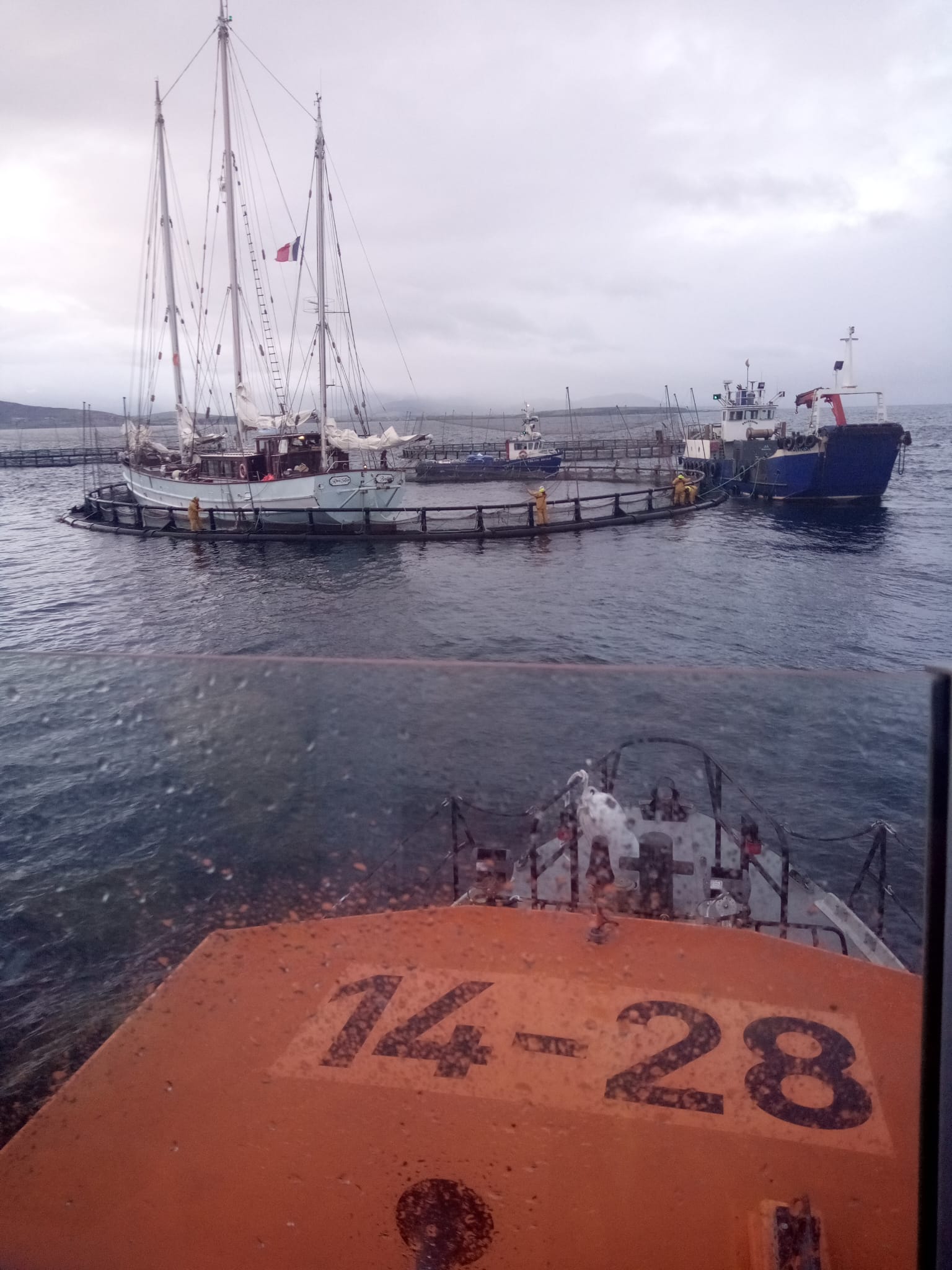 Achill Island RNLI monitoring the situation at the fish farm with the sailing vessel and other vessels in view